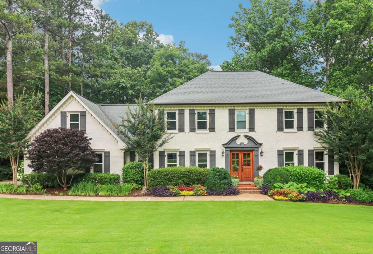 **Hardwood Floors**New exterior paint and windows**Bright open spaces**Bonus room**Finished basement with lots of room!**This elegant home is nestled on a huge lot with mature trees and beautifully maintained landscaping, offering exceptional privacy and curb appeal. Step inside to find rich hardwood floors flowing throughout the entire main level, complemented by timeless crown molding. To the left of the foyer, a spacious formal dining room features classic chair railing and ample room for hosting. To the right, a formal living room offers flexible space-perfect for entertaining, a home office, or quiet reading. The inviting family room boasts a floor-to-ceiling brick fireplace and a wall of windows that frame serene backyard views. The on-trend kitchen is a chef's dream with granite countertops, crisp white cabinetry, a tile backsplash, stainless steel appliances, a large island, and a bright breakfast room filled with natural light. A generously sized laundry room includes granite counters and ample storage, while a convenient half bath completes the main level. Upstairs, retreat to the oversized primary suite featuring hardwood floors, dual closets, and a luxurious en-suite bath with double vanities, a soaking tub, and a separate shower. A private bonus room-accessible through the primary suite or its own staircase-makes an ideal nursery, exercise room, office, or cozy den. 3 additional spacious bedrooms, all with hardwood floors, share a full hall bath with dual sinks. The partially finished terrace level expands your living space with two large living areas (one with built-ins and outdoor access), a bedroom, and a full bath-perfect for a media room, guest suite, home office, or hobby space. The possibilities are endless! Outdoors, enjoy entertaining on the freshly stained upper deck or unwind on the covered patio below. The fenced backyard offers abundant green space and backs to mature trees for a peaceful, private setting. Upgrades include but are not limited to gutters with leaf guards, sprinkler system, outdoor lighting system, new imported Mahogany wood double front door, new exterior paint, new windows. Book your tour today!