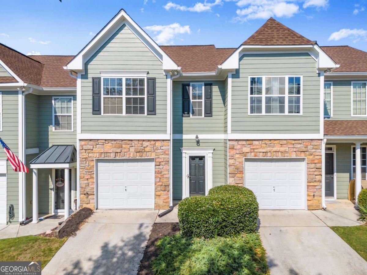 Are you looking for the lake life without the lake price? This Tide Water Cove townhome may be just what you are looking for! You'll be walking distance away from lake access, Hideaway Bay Marina, Fish Tales Restaurant, park, playground, and Downtown Flowery Branch with all the great restaurants, farmer's market and outdoor events! Just minutes away from do I-985, and more dining and shopping. This home features three bedrooms, 2.5 baths, engineered hardwood flooring downstairs, with carpet upstairs, all of which is very clean and well maintained. The larger master suite features a vaulted ceiling and unique master bath plan, with separate shower and soaking tub. The kitchen features beautiful, stained cabinets, gas oven/cooktop and has a more separated feel with the pass-through opening to the living room. You can keep warm on these cool days with a nice fire in the living room, setting the perfect atmosphere for the season.