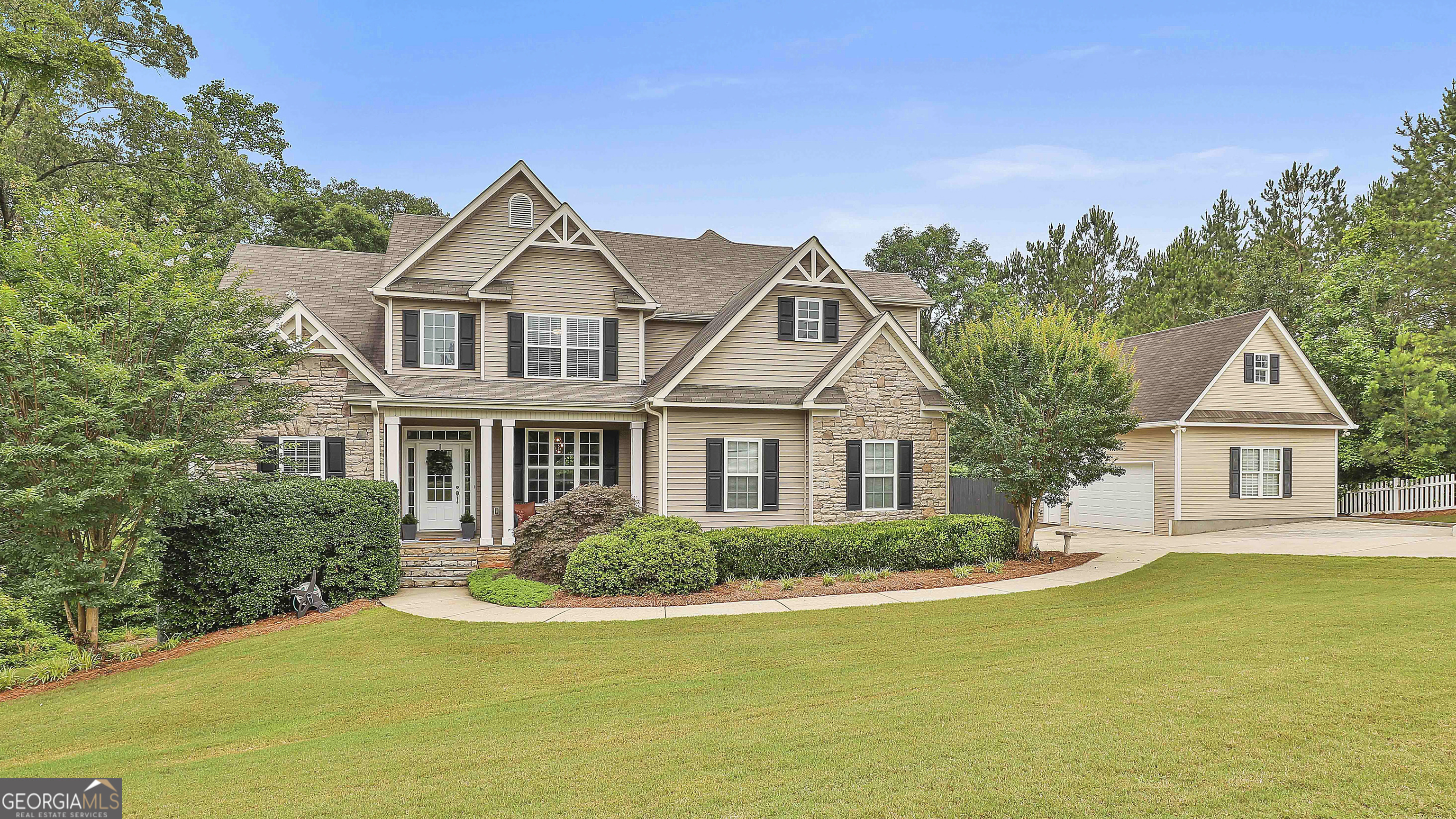 Welcome to 2975 Hickory Hill Road in Brooks-a beautifully designed home that blends modern style with craftsman charm, all set on a private 6.53 ACRE LOT. Inside, the open-concept layout is filled with natural light. The living room features a stone fireplace and flows into a crisp modern white kitchen with a large island, abundant cabinetry, and plenty of counter space. The main-level primary suite is a true retreat, complete with a spa-like bath. Upstairs, you'll find additional bedrooms, including one that functions like a second primary suite-ideal for guests or multi-generational living. All bathrooms feature MODERN, LUXURIOUS FINISHES. Step outside to a spacious wraparound deck-perfect for morning coffee or evening gatherings. The FINISHED TERRACE LEVEL features polished concrete floors, an amazing full bar, a large flex space, office/bedroom, full bath and a screened-in lounge area that overlooks the custom IN-GROUND POOL. Enjoy your own private getaway with a phenomenal pool and sauna. In addition to the attached garage, the property includes a large detached garage-perfect for a workshop, home gym, or extra vehicle storage. There's also plenty of additional storage space throughout the home, including the basement and garage areas. Every detail has been thoughtfully designed for comfort, style, and functionality. If you're looking for a retreat that feels like home, this one checks all the boxes.