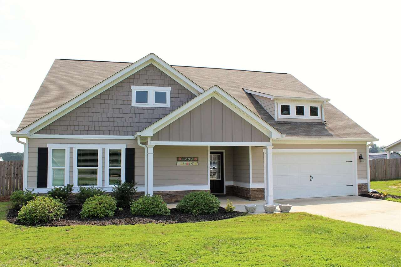 Looking for a lovely farmhouse style home away from the hustle and bustle with no HOA? Well, you've found your place to call home in this 4 bedroom, 3 bath home situated on level one acre lot with fenced in back yard. The master bedroom and bath are located on the main floor, along with 2 additional bedrooms and a guest bath. A private 4th bedroom and bath are located upstairs, which is a great place for a home office, exercise room, extra bedroom, or playroom. The ~1 acre backyard features a covered porch, outbuildings, willow tree, cherry tree, peach trees, apple trees, blackberry and muscadine bushes. It is a great place for recreation, entertaining, and gardening. The home features large walk-in closets in all bedrooms and a very open feel throughout. Great location; convenient to HWY 316, Athens & Gwinnett commuter