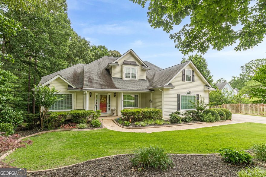 Welcome to this beautifully maintained and well-built traditional home located in the highly sought-after Arbor Crossing neighborhood. From the moment you enter the welcoming foyer with gleaming hardwood floors, you'll feel right at home. Offering 5 bedrooms and 4.5 baths, including master suite on the main level complete with a large walk-in closet, double vanities, a soaking tub, and separate shower. Freshly painted. Enjoy entertaining in the formal dining room, or relax in the two-story great room featuring a cozy fireplace and expansive windows. The chef's kitchen with cabinetry, a built-in desk area, and opens seamlessly into a sunny breakfast room - perfect for casual gatherings. Additional highlights include a large laundry room and half bath on the main level, and a spacious deck overlooking the private, wooded backyard - ideal for outdoor living. Upgrades include new windows and a new deck in 2015. The full basement offers endless potential for expansion, whether you're dreaming of a home theater, gym, or additional living space. Located in a prime location, this home offers convenient access to top-rated schools, shopping, dining, and the Atlanta Airport. Don't miss the opportunity to make this exceptional property your forever home!