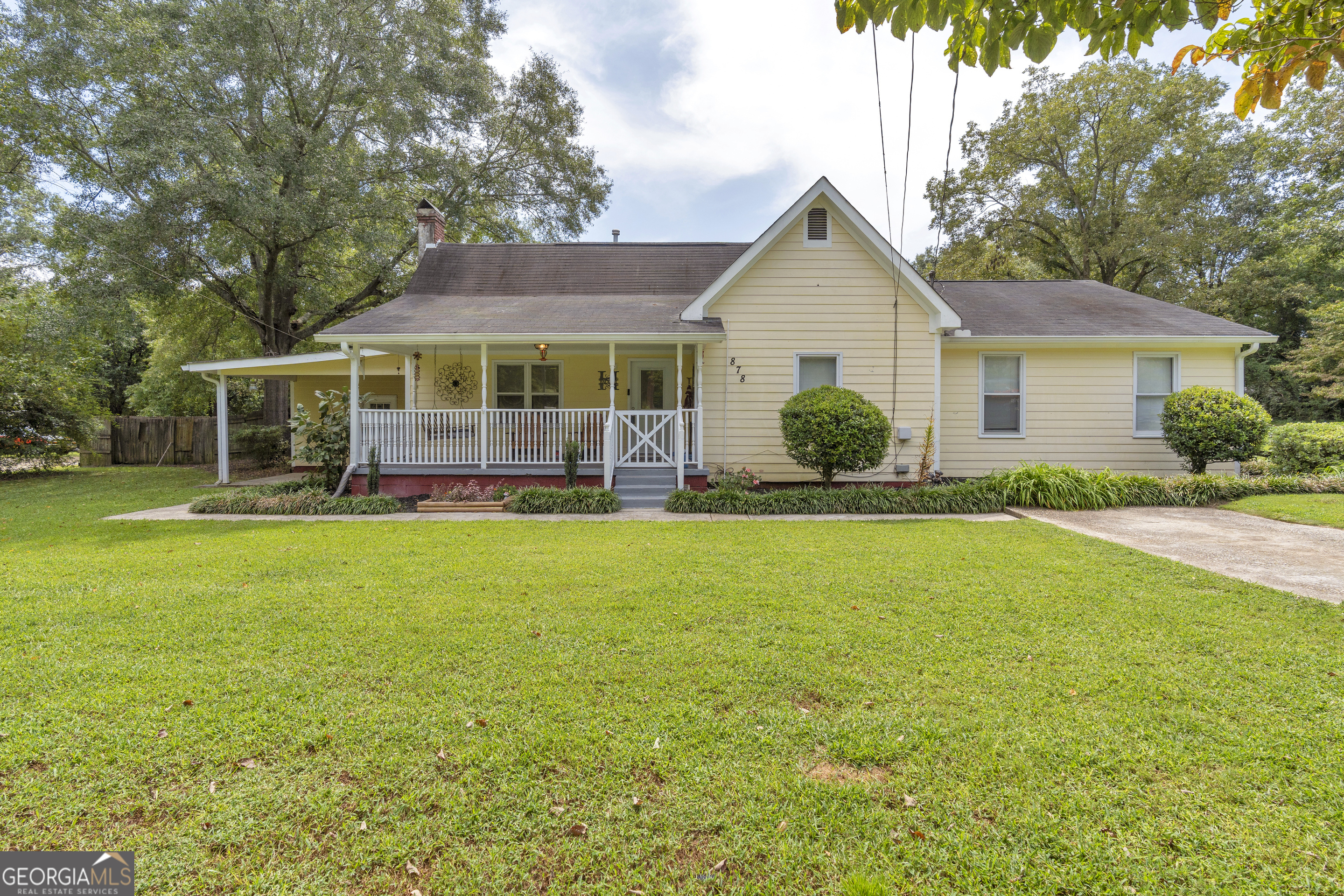 This 1900's farmhouse offers a comfortable layout with 4 bedrooms, 2 full bathrooms, and a flexible bonus room that can be used as an office, hobby space, or extra bedroom. The living room features a brick fireplace, adding a touch of warmth and a natural gathering spot for the home. Off the living room is the country kitchen, designed with backsplash and built-in shelving, and a convenient laundry closet. The owner's suite is a true retreat with direct access to a private deck area-perfect for sipping your morning coffee or winding down in the evening. Newer carpet runs throughout the home, adding comfort and warmth. Outside, you'll find a partially fenced backyard, a storage building/workshop for projects and extra storage, and plenty of space to enjoy the outdoors. Located just minutes from downtown Locust Grove, you'll love being close to local shops, dining, and community events while still enjoying the peaceful feel of farmhouse living. Don't miss the chance to make this timeless property your new home!