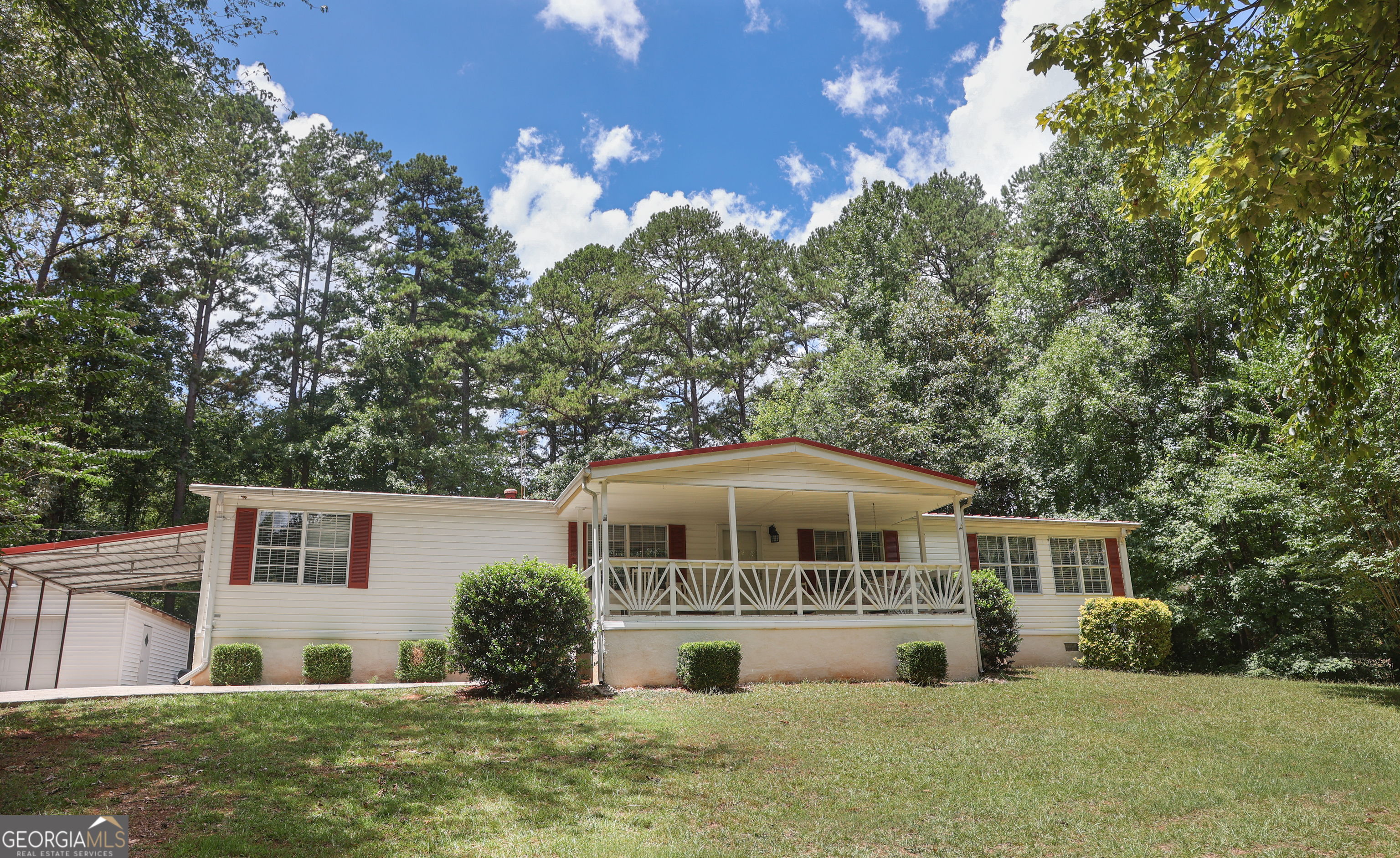 This is an outstanding home with a flexible layout, great location, and immaculate condition. The three-bedroom mobile home serves as the perfect family residence. Featuring a split floor plan, the master suite is located on one side of the house, while the other two bedrooms are situated on the opposite side. The central living area, located at the heart of the home, is ready to be filled with family memories. The spacious kitchen leads to the laundry room, enhancing functionality. Outdoor you will find two porches and a gazebo perfect for morning coffee! Also, a carport provides convenient parking and a detached garage is great for hobbies and toys!