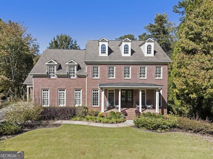 This exceptional Monte Hewett home is perfectly situated on a quiet cul-de-sac in the heart of North Buckhead, and offers a rare combination of architectural sophistication, timeless craftsmanship, and modern livability. Surrounded by beautifully landscaped grounds, this four-level residence is designed for both elegant entertaining and comfortable everyday living. A gracious front porch with gas lanterns welcomes guests into a light-filled interior with 10-foot ceilings on both the main and terrace levels. The stunning gourmet kitchen features walls of windows, quartz countertops, a large center island, new premium appliances, and a breakfast area with custom built-in banquette that opens to an outdoor dining area and kitchen, creating seamless indoor-outdoor flow. The kitchen flows into the keeping room with fireplace, the perfect spot for relaxed gatherings. The spacious family room showcases coffered ceilings, a fireplace, and custom built-ins, while the screened porch overlooks the manicured backyard and a peaceful nature preserve in the distance. A butler's pantry with ice maker connects to the formal dining room, easily accommodating twelve guests. A front living room offers flexible use as a music, game, or Mah Jongg room. Completing the main level are a mudroom with abundant storage and two stylish powder baths. Upstairs, the luxurious primary suite features a fireplace, private sitting room, and a spa-like bath with double vanities, soaking tub, separate shower, and an expansive walk-in closet. Three spacious secondary bedrooms, two full baths, and a landing area with a built-in reading nook complete this level. The fourth floor offers exceptional flexibility-ideal as a media room, home office, craft room, or play space. The terrace level is a true extension of the home, featuring a daylight media/family room with custom cabinetry, temperature-controlled wine cellar, game room, exercise room (optional 6th bedroom), guest suite, 1.5 baths, office, and French doors leading to a private backyard patioIdeally located within walking distance to Sarah Smith Elementary, and moments from PATH400, Chastain Park, and Buckhead's finest shopping, dining, and entertainment, this exquisite home offers an unparalleled lifestyle in one of Atlanta's most coveted neighborhoods.