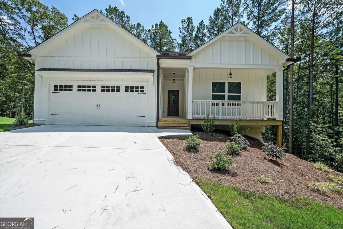 SO excited to announce NEW CONSTRUCTION by Rivermont Homes in the beautiful community, WEST WOODS! Fabulous location in Dahlonega just minutes from UNG campus offering Lumpkin county's finest schools and all the shopping close by in Dawsonville and the lovely downtown Dahlonega Square!!! The Oconee plan is a 3 bedroom 2 bath RANCH on a basement situated on .74 acres with a private wooded view. Entering this adorable home you have a spacious foyer leading to the living room which is open to a bright white kitchen featuring quartz countertops, large island, farmhouse sink and stainless steel appliances. A spacious master suite and the luxurious bath has a double vanity with quartz countertops, tile floor and large shower with bench. The 2 guest bedrooms offer ample space and closets with a shared hall bath. Home is READY NOW