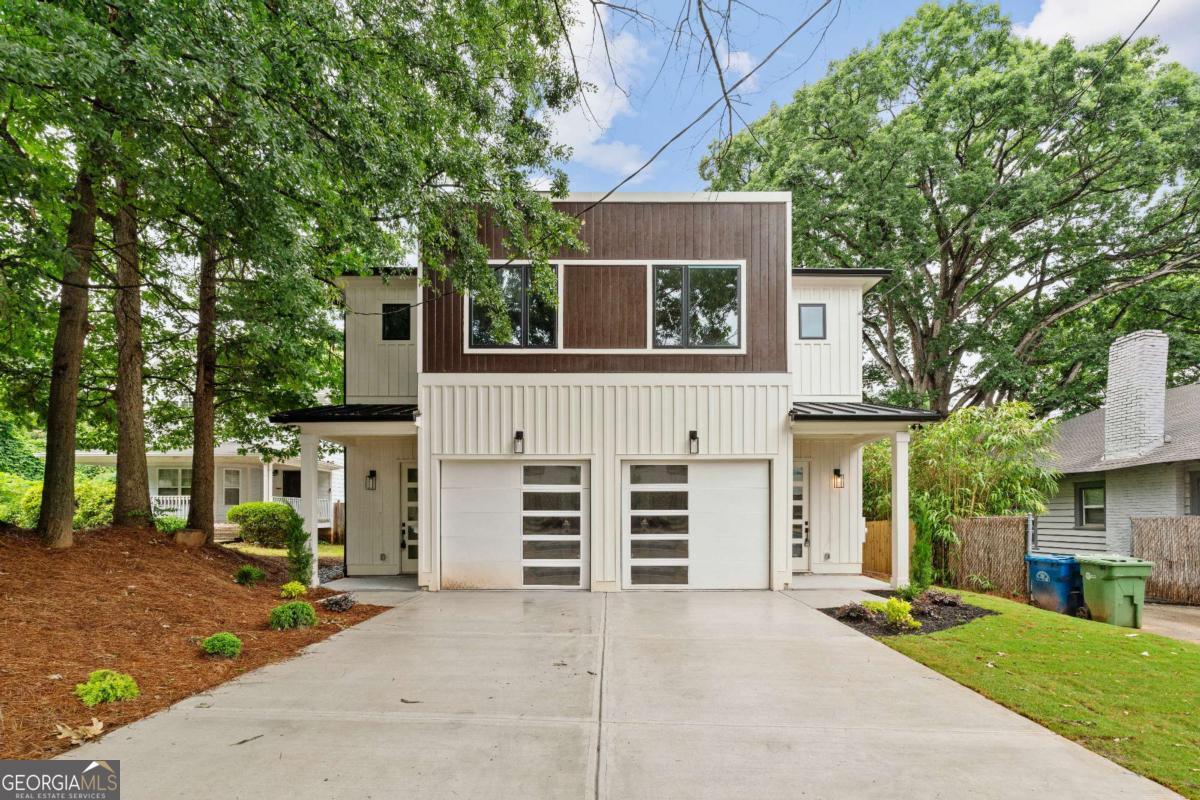 Elegant new construction with a private fenced yard, at a hard-to-find price point. Enter the wide front foyer to soaring 10-foot ceilings and stunning finishes in this well-designed townhouse. The open floorplan boasts accent walls, custom lighting and plumbing fixtures, and natural hardwood floors. Don't miss the upgraded "thin" shaker cabinets and oversized quartz island in this impressive kitchen. Separate, but open, dining area flows seamlessly to the back patio and the ample backyard! The open living room is anchored by a cozy fireplace with quartz surround. Main level also features a stylish half bath, mudroom with built-ins, and attached garage, with 240-volt plug-in for electric vehicles. Upstairs you will be wowed by the bonus loft living area, three bedrooms and two more bathrooms. The primary suite will not disappoint - accent walls, sunny bath with dual vanity, dual shower heads and upgraded finishes, and a large private porch with treetop views so peaceful you might forget you're minutes from the Beltline, Madison Yards, Edgewood Retail District, Ponce City Market, and much more. Intown living at its finest!