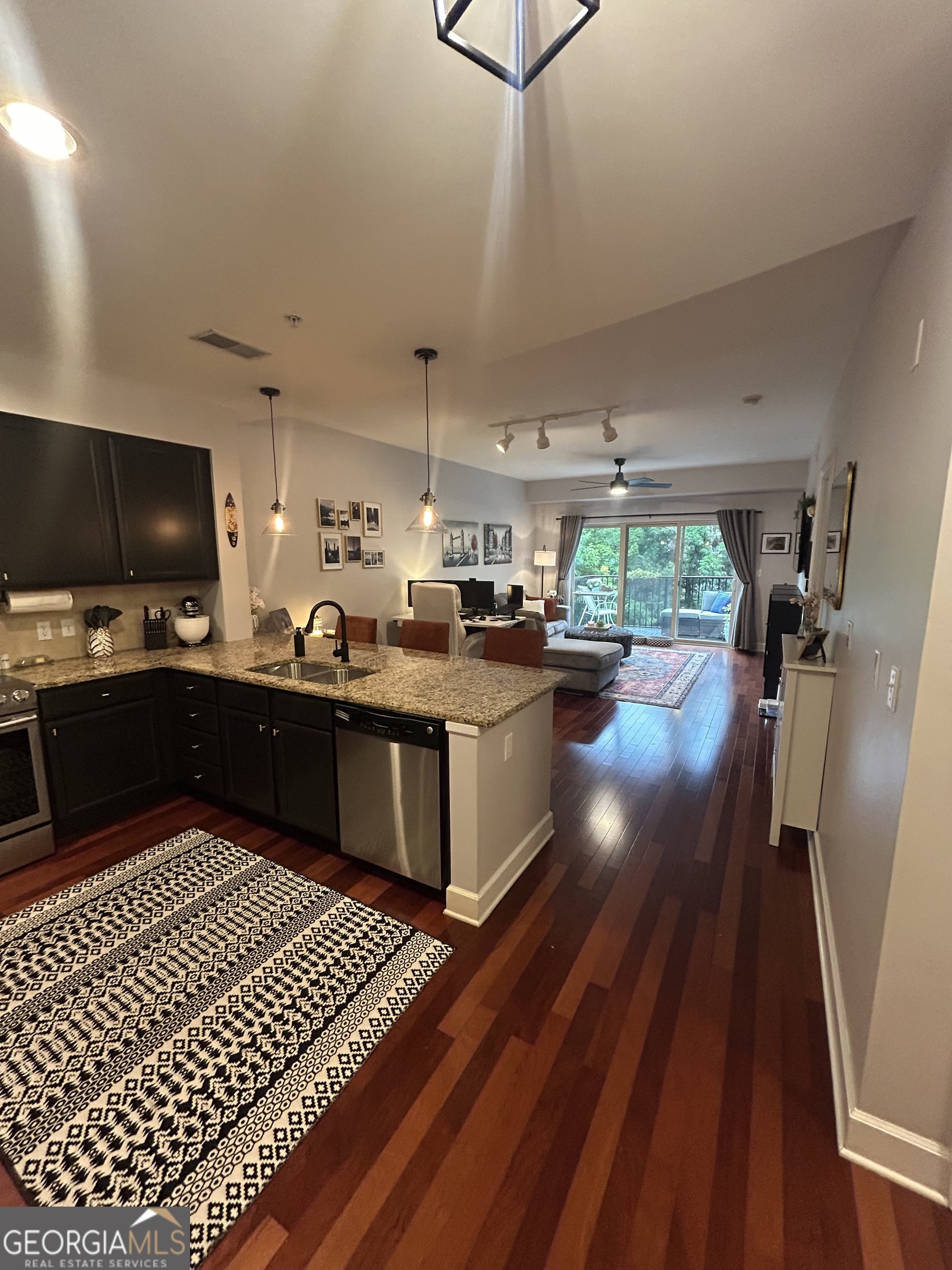 Enjoy resort-style living in this beautifully maintained 1BR/1BA condo at River House-one of Atlanta's most sought-after gated communities. Step into a light-filled, open-concept living space with floor-to-ceiling sliding doors that open to a private balcony surrounded by lush, tree-lined views. The outdoor area offers the perfect retreat for morning coffee or evening relaxation. Inside, the spacious bedroom features plantation shutters and a custom built-in storage system that remains with the unit-providing both function and style. Neutral tones, designer touches, and abundant natural light create a warm and inviting atmosphere throughout. For added convenience, this condo includes a dedicated, assigned parking spot just steps from the building Located on 33 acres along the scenic Chattahoochee River, River House offers an exceptional array of amenities designed for comfort, convenience, and community. Residents enjoy 24-hour gated security and concierge-style management, ensuring peace of mind and a welcoming environment. The community features two saltwater pools, a beautifully appointed clubhouse with a 24/7 fitness center, a spa treatment room, and a cozy coffee lounge for relaxing or catching up with neighbors. Outdoor amenities include a fire pit, grilling areas, a dog park, and multiple green spaces perfect for enjoying nature. For those who love the outdoors, the Cochran Shoals Trail is just half a mile away, providing easy access to miles of walking, running, and biking paths along the river. Plus, River House is conveniently located near Truist Park and some of Atlanta's top dining destinations, including Ray's on the River and Mojave. Perfect for professionals, nature lovers, or anyone seeking comfort and convenience in a peaceful setting. Don't miss this opportunity to own a turnkey condo in one of Atlanta's premier communities!