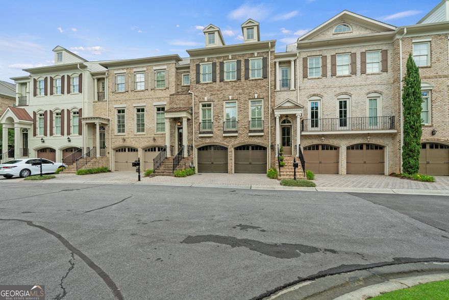 AMAZING LOCATION! Tucked within an exclusive gated enclave, this stunning three-bedroom, three-and-a-half-bath townhome offers luxurious living with timeless design, custom built by the renowned John Willis Homes. Thoughtfully designed with elevator-ready access, the residence blends elegance and convenience across every detail.    Upon entry, you're welcomed by beautifully appointed interiors featuring spacious open-concept living areas, rich hardwood flooring, and designer finishes throughout. The fireside master suite offers a tranquil retreat with a cozy fireplace, spa-like bath, and expansive walk-in closet. Step out to your private screened porch from the main living level-perfect for relaxing or entertaining while enjoying peaceful views.    The chef's kitchen seamlessly flows into the dining and living spaces, ideal for modern living and hosting. The garage is a dream-fully insulated with custom built-in cabinetry, a sink, and refrigerator, perfect for storage or hobby space.    Just a short walk to shops and restaurants, this home is ideally located within a vibrant, well-maintained community. Enjoy lighted, tree-lined sidewalks that lead to an impressive array of amenities: a resort-style swimming pool, tennis courts, state-of-the-art exercise facility, wooded walking trails, playground, basketball court, business center, and a sprawling green space along the scenic Chattahoochee River.    This residence offers the perfect blend of luxury, lifestyle, and location-your private retreat in a vibrant, amenity-rich community.