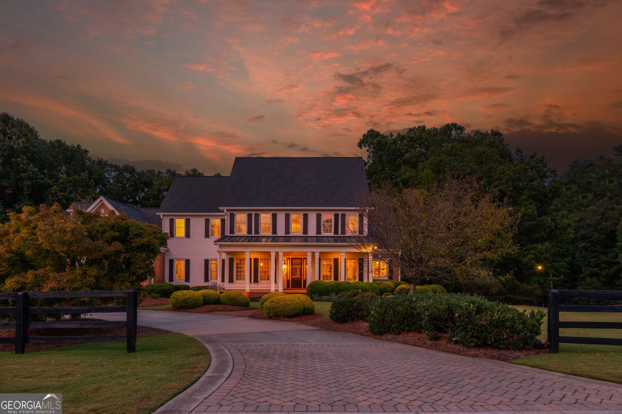 Experience timeless elegance and serene living in this custom-built estate by award-winning Chatham Homes, set on 2.5 acres in the exclusive Shoals at Arbor Hill community. This 6-bedroom, 6.5-bath residence showcases refined craftsmanship and luxurious details throughout. A welcoming Southern porch and dramatic two-story foyer lead to a large dining room with exquisite architectural accents. The living room features a coffered ceiling, built-ins, and French doors opening to a spacious deck overlooking the private backyard. Additional highlights include a butler's pantry, laundry room with office space, and abundant storage. The gourmet kitchen is the heart of the home, offering stainless steel appliances, custom cabinetry, an oversized island, and expansive counters, flowing seamlessly into a bright keeping room with fireplace. The main-level owner's suite is a private retreat with fireplace, sitting area, dual walk-ins, and a spa bath with soaking tub, dual vanities, and walk-in shower. Upstairs are four en-suite bedrooms, each with a walk-in closet. Enjoy outdoor living from the covered porch or terrace level, complete with bedroom suite, kitchenette, recreation space, and storage. The grounds feature a French-style garden, koi pond, stone fire pit, and custom stream with waterfalls. Adding to its appeal, The Shoals at Arbor Hill is an equestrian-friendly community, allowing horses on property with HOA approval -a rare lifestyle opportunity. Minutes from shopping, dining, and top-rated schools, this home offers unmatched luxury, privacy, and serenity. Welcome Home.