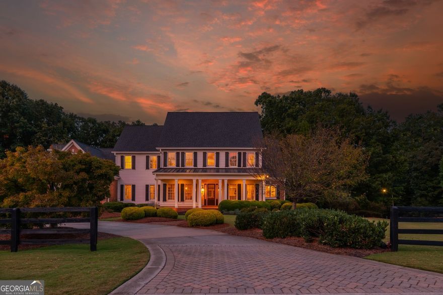 Experience timeless elegance and serene living in this custom-built estate by award-winning Chatham Homes, set on 2.5 acres in the exclusive Shoals at Arbor Hill community. This 6-bedroom, 6.5-bath residence showcases refined craftsmanship and luxurious details throughout. A welcoming Southern porch and dramatic two-story foyer lead to a large dining room with exquisite architectural accents. The living room features a coffered ceiling, built-ins, and French doors opening to a spacious deck overlooking the private backyard. Additional highlights include a butler's pantry, laundry room with office space, and abundant storage. The gourmet kitchen is the heart of the home, offering stainless steel appliances, custom cabinetry, an oversized island, and expansive counters, flowing seamlessly into a bright keeping room with fireplace. The main-level owner's suite is a private retreat with fireplace, sitting area, dual walk-ins, and a spa bath with soaking tub, dual vanities, and walk-in shower. Upstairs are four en-suite bedrooms, each with a walk-in closet. Enjoy outdoor living from the covered porch or terrace level, complete with bedroom suite, kitchenette, recreation space, and storage. The grounds feature a French-style garden, koi pond, stone fire pit, and custom stream with waterfalls. Adding to its appeal, The Shoals at Arbor Hill is an equestrian-friendly community, allowing horses on property with HOA approval -a rare lifestyle opportunity. Minutes from shopping, dining, and top-rated schools, this home offers unmatched luxury, privacy, and serenity. Welcome Home.