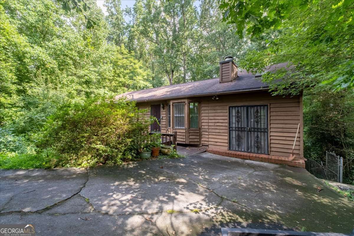 Here is a chance to reimagine and create a mid century modern ranch home in Hot Medlock Park in Decatur. This home already has a unique layout that you have to experience first hand to see how this has potential for being a design/build playground with its 2 story room with fireplace and jacuzzi in the back overlooking the woods, trap door down to a private screened porch and loft bedroom on one end of the home. The other option is to tear down for new construction. Fun fact. This is the former home of the Real Doc Hollywood. Here you have a very deep, wooded lot in the back to expand the home design back or maek room to build a new, larger home. Notice the true log cabin with fireplace in the back yard that needs a little TLC, but has a previously patented pulley system to move the roof from the main cabin to the porch and back. Bring your contractor or builder and create your own vision. And, as location is everything...this location is close to Emory, City of Decatur (without paying the city taxes) and walkable to Medlock Park's pool, playground, and baseball fields. And, if you love to take walks in the woods, look no further. Medlock Park neighbors enjoy the use of South Peachtree Creek Trail, a paved greenway connecting Medlock Park to Mason Mill Park, and various unpaved "social trails". The South Peachtree Creek Trail is part of the PATH Foundation network and features a boardwalk section. You also have direct access to Clyde Shepherd Nature Preserve and trails. Intown living that is steps away from nature. This is an As Is sale. Fryer Law Firm Decatur location is the preferred closing attorney. Property priced below appraisal amount.