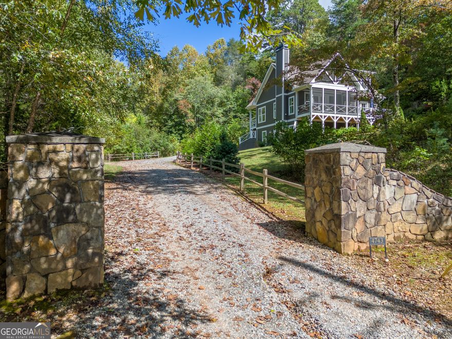 Built in 2020 on a 1.7acre FEE SIMPLE lot, this charming 3 bedroom, 2 bath cottage comes with an oversized private swim dock and lakeside pavilion on Lake Burton. The home sits on a private lot with a view of the lake from the screened porch. The open great room features a vaulted ceiling and family room with stone fireplace, a well-equipped kitchen with quartz countertops and stainless appliances and a dining area for 6+. The family room opens to a screened porch with a lake view that opens to a grilling/dining deck. The main floor primary suite features an en-suite bath and a main floor guest bedroom accesses a full bath also accessible from the hallway. A laundry closet is located at the end of the hallway. Upstairs, a spacious loft houses twin beds with room for expansion. The half finished basement is plumbed for a full bathroom and features a generous media room and game area with a set of bunk beds. A large unfinished area provides opportunity for expansion. Across the road, a private swim dock and screened pavilion with built-in bar and lounge area provide the perfect setting for enjoying Lake Burton. Set back in a protected cove, the swim dock offers views of the main body of Lake Burton with a direct view of Billygoat Island and the 4th of July fireworks. Furnishings are negotiable.