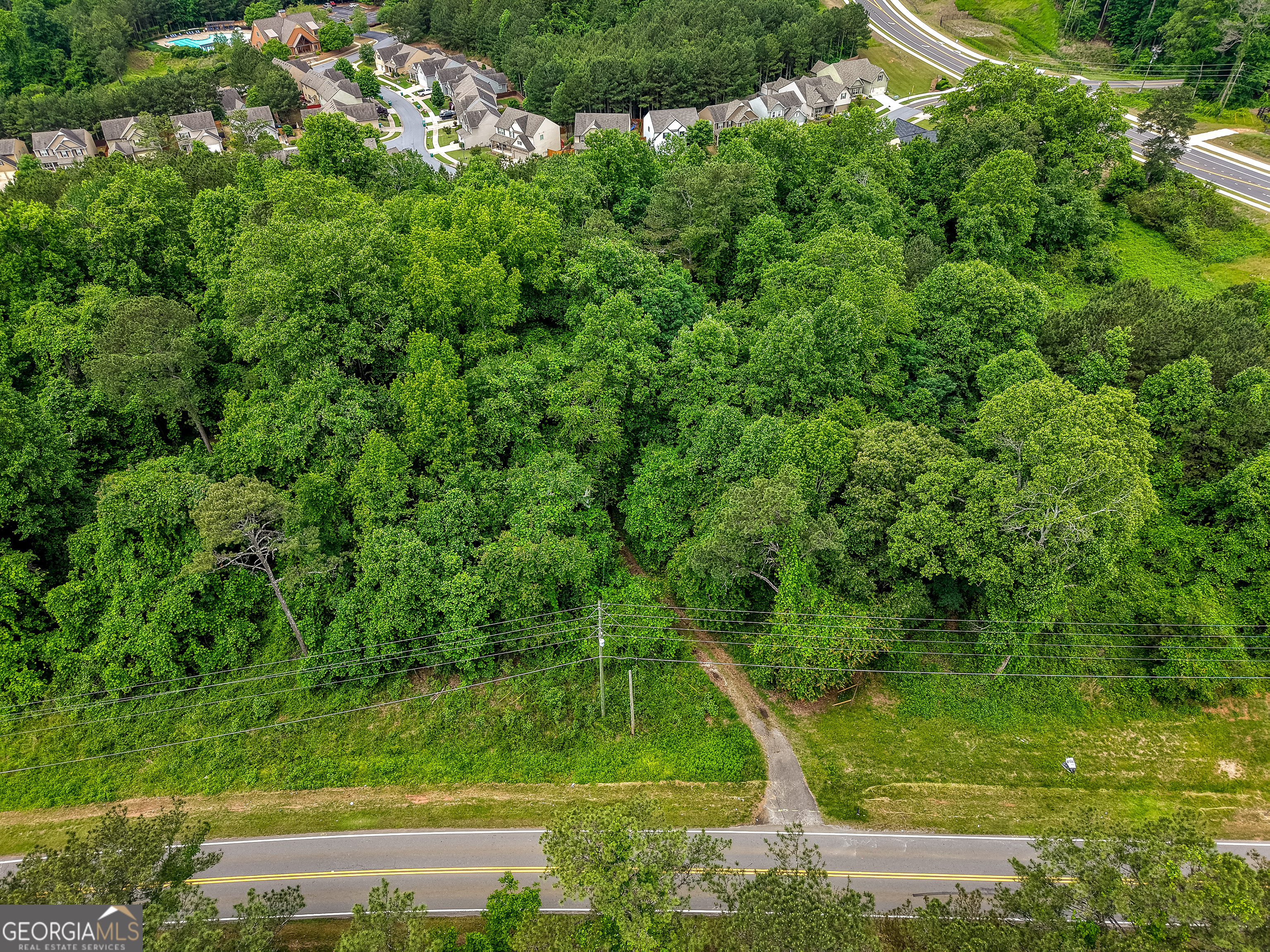 Investors and Developers...Prime Development Opportunity Near Fate Conn Road & Heard Road...Priced below recent appraisal! Land lies within the City of Canton's Future Development Corridor as suburban development as notated within their 2045 Comprehensive Plan (see in documents section). Positioned just off the new major roundabout at Fate Conn Road and Heard Road, this exceptional tract of land lies in a rapidly developing corridor-making it a strategic investment opportunity. The property is surrounded by established and desirable communities such as Riverstone, Great Sky, and The Bluffs, and is located less than one mile from the scenic Hickory Log Creek Reservoir boat launch. With immediate access to I-575, retail, dining, and daily conveniences, this location combines accessibility with long-term growth potential. The land is equipped with county water and a septic system, offering flexibility for a variety of uses-residential, commercial, or mixed-use development. Current county guidelines should allow for the development of up to five lots with septic, with potential for increased density contingent on extending sewer service from nearby infrastructure as property is adjacent to city along it's eastern boundary. This makes the property ideal for a boutique subdivision, or a light industrial/storage facility or potential for high density development within that mix of options with county or city approval. Important Note: The existing structure on the property is not habitable and should be considered a tear-down. Entry into the home is strictly prohibited without prior written authorization from the listing agent.