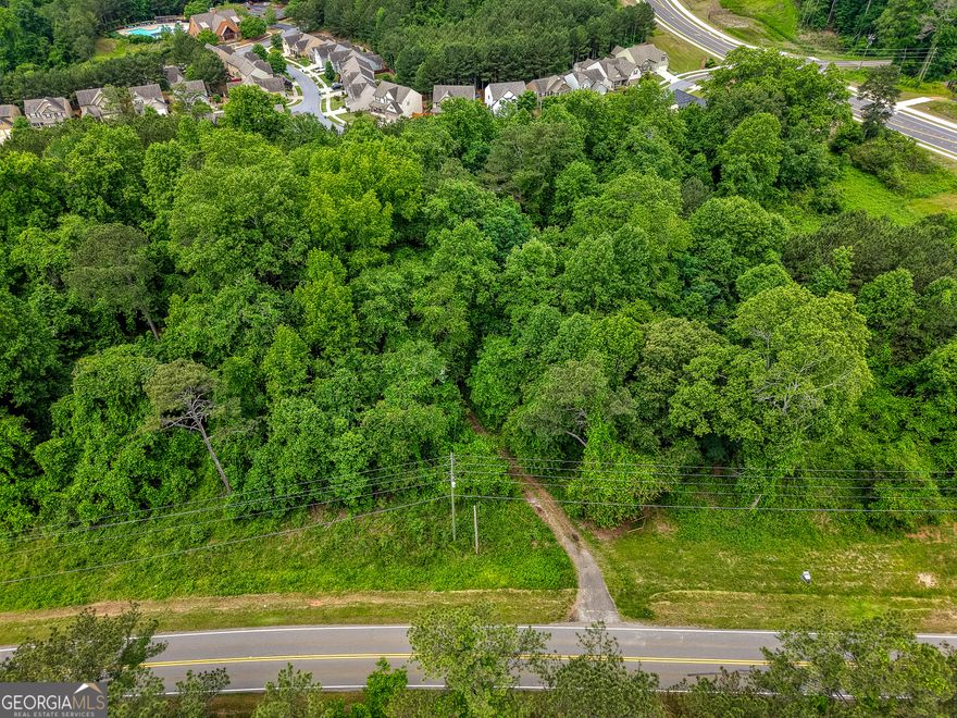 Investors and Developers...Prime Development Opportunity Near Fate Conn Road & Heard Road...Priced below recent appraisal! Land lies within the City of Canton's Future Development Corridor as suburban development as notated within their 2045 Comprehensive Plan (see in documents section).    Positioned just off the new major roundabout at Fate Conn Road and Heard Road, this exceptional tract of land lies in a rapidly developing corridor-making it a strategic investment opportunity. The property is surrounded by established and desirable communities such as Riverstone, Great Sky, and The Bluffs, and is located less than one mile from the scenic Hickory Log Creek Reservoir boat launch. With immediate access to I-575, retail, dining, and daily conveniences, this location combines accessibility with long-term growth potential.  The land is equipped with county water and a septic system, offering flexibility for a variety of uses-residential, commercial, or mixed-use development. Current county guidelines should allow for the development of up to five lots with septic, with potential for increased density contingent on extending sewer service from nearby infrastructure as property is adjacent to city along it's eastern boundary.  This makes the property ideal for a boutique subdivision, or a light industrial/storage facility or potential for high density development within that mix of options with county or city approval.     Important Note: The existing structure on the property is not habitable and should be considered a tear-down. Entry into the home is strictly prohibited without prior written authorization from the listing agent.
