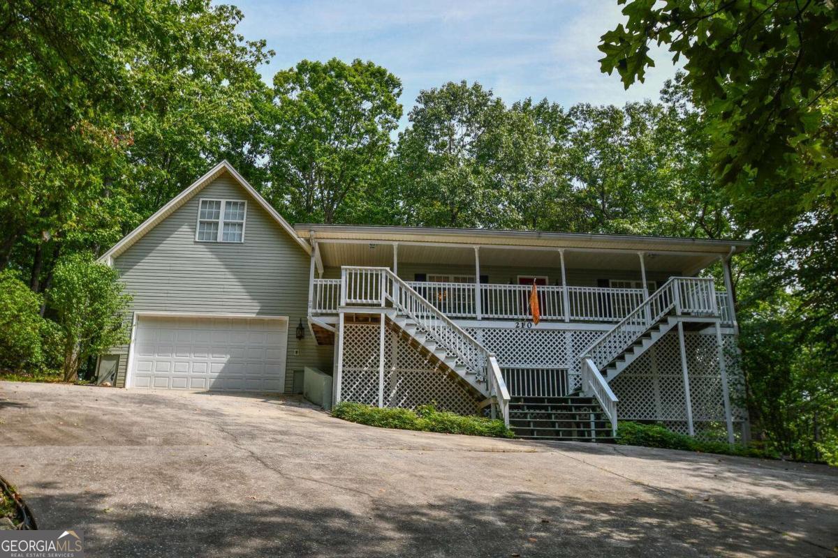 Tucked among the trees on 1.7 wooded acres, this custom-built three-bedroom, three-bath home offers the perfect blend of privacy and community. Expansive covered porches invite you to unwind as you watch deer and other wildlife pass through, creating a peaceful retreat right outside your door. Inside, a warm and inviting living space centers around a beautiful gas fireplace, complemented by a split floor plan that provides comfort and privacy. The kitchen features solid surface countertops, and the fully finished basement-with its own wet bar-adds an ideal space for entertaining or hosting guests. Located in the heart of mountain country, you'll be close to wineries, kayaking, hiking, and charming local shops, with access to all the amenities of Mountain Lakes Resorts. It's a serene mountain escape and a wonderful place to establish roots.