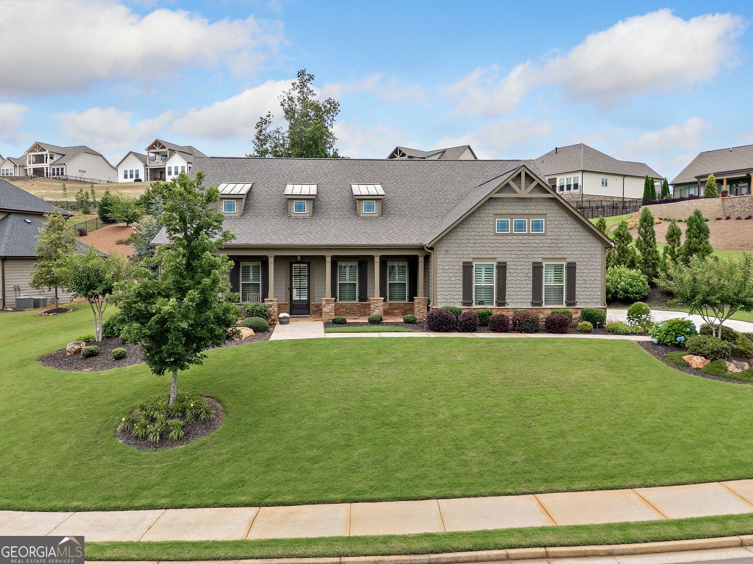 Welcome to your better than new beautifully designed Craftsman-style ranch with loft, perfectly positioned on over half an acre in one of Canton's most highly sought after neighborhoods. Built by renowned luxury builder Patrick Malloy, this home exudes warmth, elegance, and architectural integrity, while offering modern comfort at every turn. As you step inside, you're greeted by soaring ten-foot ceilings, detailed crown molding, and rich wood flooring that flows throughout the main level, setting a tone of refined sophistication. As you enter, a substantial sized secondary bedroom with ensuite bath has been converted to a home office. To the left, a generously sized dining room that connects to a butler's pantry and walk-in pantry. The heart of the home is an open concept living space anchored by a stunning gas fireplace flanked by built-in bookcases. Granite countertops stretch across generous prep space, complemented by a matching granite backsplash and stainless-steel appliances. An oversized island as well as an eat-in kitchen invites guests to gather, creating a perfect environment for both everyday living and elevated entertaining. The primary suite is a retreat unto itself, with peaceful views of the backyard and a well-appointed bathroom featuring two separate vanities and an additional cosmetic vanity as well as a luxurious temperature controlled washlet toilet seat. Each of the four bedrooms offers its own ensuite bathroom, ensuring privacy and comfort for both family and guests. Outside, a professionally landscaped front and backyard offers both beauty and tranquility, enhanced by curated lighting and a motorized awning that shades the stone patio-perfect for relaxing mornings, afternoon cookouts, or evening drinks under the stars. Every inch of the home has been immaculately maintained by its original owners and thoughtfully enhanced with features like new plantation shutters, a freshly painted exterior, a brand-new water heater, washer and dryer, and dishwasher. Additional highlights include a Simply Safe security system, Google smart thermostats with dual-zone climate control, energy-efficient spray foam insulation, epoxy-coated garage floors, and an in-wall pest control system-all adding to the home's quiet sense of luxury and effortless livability. With a side-entry two-car garage and impeccable finishes throughout, this residence is move-in ready and truly better than new. For buyers seeking convenience and a fully curated lifestyle, the home can even be sold turnkey with a strong offer and a separate bill of sale. Living in Horizon at Laurel Canyon means more than just a beautiful home, it's a lifestyle. Residents enjoy access to the semi-private Fairways of Canton golf course, tennis and pickleball courts, a fitness center, swimming pool, playground, basketball court, and miles of scenic sidewalks, all just moments from top dining, shopping, and the charm of downtown Canton. Your new home offers the perfect fusion of craftsmanship, comfort, and community. Come experience the quality, care, and character of this extraordinary home in person-because some homes simply can't be appreciated until you feel them for yourself. Sellers have included a complimentary 1-Year Home Warranty!