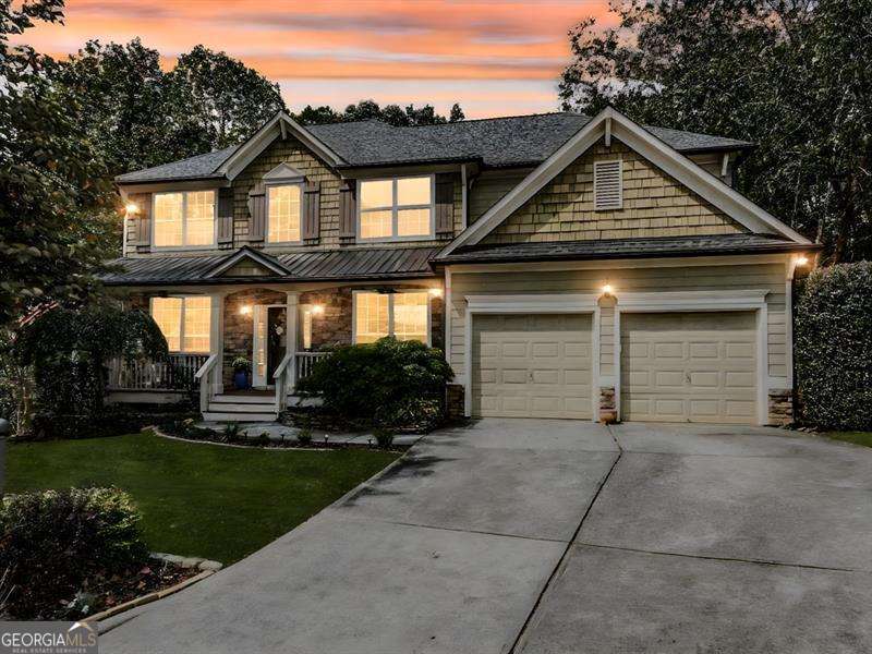 Welcome to this stunning move-in ready craftsman style home, nestled in a peaceful cul-de-sac and designed for both comfort and style. Rocking chair front porch, perfect for morning coffee or evening relaxation. This home offers 5 bedrooms, 4 full bathrooms, and a finished basement, this turn-key home is perfect for families who love to entertain and enjoy plenty of space. Bright and open floor plan featuring an office room and a separate dining room for formal gatherings. Main floor also has a bedroom and full bathroom. Kitchen is open concept with views to the living room. Nice kitchen island with plenty of space to entertain guests. Upstairs you will find an oversized master suite with a cozy sitting room, a custom walk-in closet, and luxurious bathroom. Secondary bedrooms are large and inviting. Step down to the basement where you will find additional living space, ideal for 2nd living room, media room, gym or play area. Basement also has a custom wet bar with sink - perfect when you have company over! Walk outside and find a freshly stained deck with views to the backyard. Covered patio and backyard is fenced in. This home blends craftsman charm with modern convenience, making it a rare find that won't last long. Conveniently located close to shopping, restaurants, schools, DOWNTOWN CANTON and THE MILL. Districted for the NEW CHEROKEE HIGH SCHOOL. Enjoy resort style living with top tier amenities, pools, tennis, pickleball, clubhouse, year-round events, trails, playground, basketball, fishing and more.
