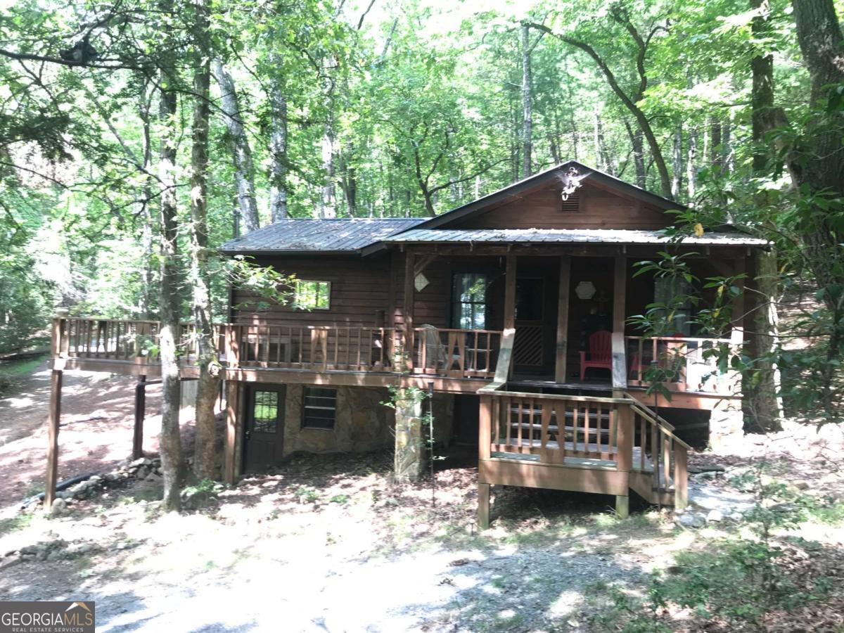 Privacy! Privacy! Privacy!....If nature, woods, and lots of privacy are what you are looking for, then this cabin is for you!! Picturesque cozy cabin nestled in the woods on a 2 acre lot. Less than 1 mile to Toccoa River, Aska Adventure launch and the Sandy Bottoms recreation area. 5 miles to world class guided fishing and sporting clays at Noontootla Creek, 7 miles to Fine Dining at Toccoa Riverside Restaurant, 2 miles to local general store and kitchen / eating. Adventure awaits in all directions, but if you just want to stay home and have a quiet retreat this will meet both of those needs. Short drives to lots of, hiking, tubing, kayaking, apple picking and within a 20 min drive of downtown Blueridge. Beautiful serene views of the area from your wrap around porch. Home is large for 1 bedroom, couch is a sleeper sofa, but could possibly redesign / locate family room and convert existing family room into a bedroom to potentially make it a 2 bedroom. NO HOA...If you would love to own a private mountain retreat do not let this one slip by... AWD / or 4WD recommended for final approach in and out of the homesite. Some cars with 2wd have gotten stuck coming up the the hill when LEAVING the cabin...if unsure, please park on the gravel road after turning on the fork to the left as described in the directions, please do not block the neighbors. AWD / 4WD should not have any issues on the final hill in and out of the cabin...as we said...it is very private!!!