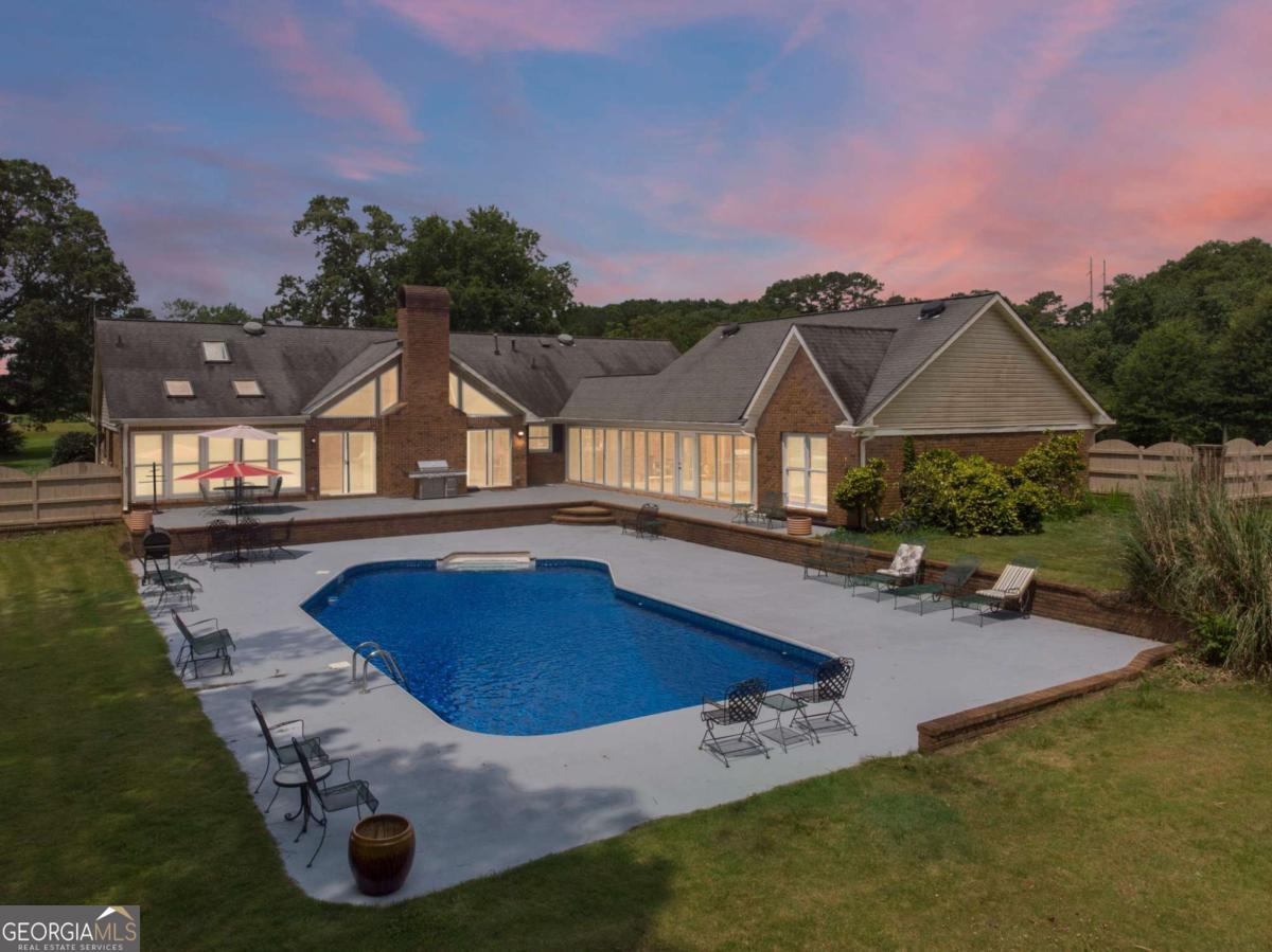 This private pool house near Atlanta is an ideal place to relax. This property sits on 3.5 acres of land and in one of the safest neighborhoods near Atlanta. Provided indoors on the property: karaoke, board games, video games and hot tub; pool table and table tennis (breezeway); outdoors: horseshoe set, swing, firepit, BBQ grill (gas and charcoal), cooler and swimming pool (only available May to September.) This 2700 sq ft ranch sleeps 10 with 5 queen beds, 5 TVs, and dining table seats 10. Property is 1.7 miles to downtown Fayetteville, 4 miles to the Pavilion, 4 miles to Trilith Studios, 10 miles to Fun Spot America and 25 miles to Hartsfield International Airport.