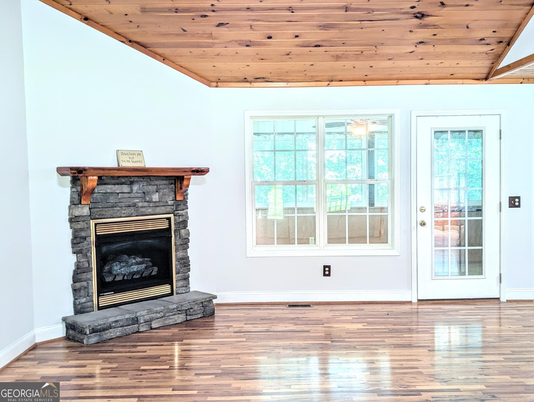 OPEN HOUSE SATURDAY 7/26 2-4:00 PM . Interior is currently being painted a neutral color through out. Welcome to this inviting 3-bedroom, 2 bath home offering the perfect blend of comfort and functionality. Nestled on a private 1+ acre lot, this home features a well-thought-out floor plan that makes everyday living a pleasure. As you enter, you'll be greeted by a large and open living room with stunning tongue-and-groove partially vaulted ceilings that enhance the spaciousness. The cozy fireplace adds a touch of warmth and ambiance to the room. The elegant dining room boasts trey ceilings, creating an ideal space for entertaining guests or enjoying family meals. The well-appointed guest rooms provide ample space for comfort, with a guest bathroom featuring tile flooring. The large master suite is a true retreat with a trey ceiling, hardwood floors, walk-in closets, and a beautifully designed ensuite bathroom. The kitchen is open to the living room and includes a breakfast nook, making it easy to stay connected with family and friends. For added convenience, the laundry room is located just off the kitchen, with easy access to the breezeway leading to the garage. Enjoy the outdoors year-round with a spacious sunroom (not included in heated sq ft) located just off the living room, perfect for relaxing and unwinding while overlooking the backyard. Step outside onto the back deck, where you can take in the serene, private backyard and wooded area while grilling your favorite meals. The front porch is a perfect spot to sit and enjoy the beauty of flowering plants and trees that surround the home. Additional features include a storage area beneath the sunroom and a quiet, peaceful location just minutes from town. Don't miss your chance to experience this lovely home with all its charm and potential. Schedule a tour today