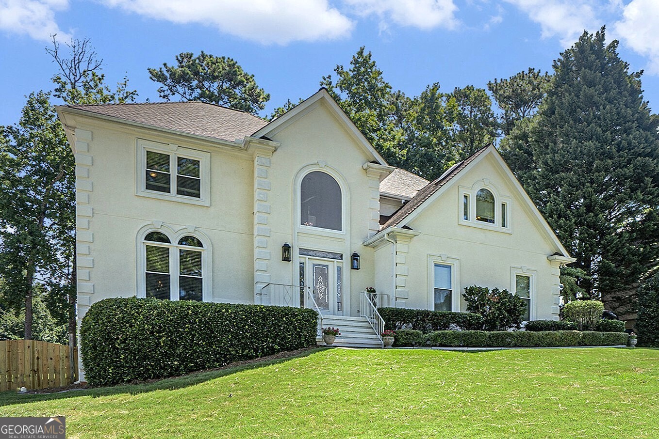 Traditional Charm in the Heart of the Sought-After Brookwood Community! Nestled in a well-established neighborhood with beautiful landscaping and the option to join the swim/tennis club and lake amenities, this spacious home offers an incredible lifestyle within the award-winning Brookwood School District. A Grand Two-Story Foyer welcomes you inside, setting the stage for the classic elegance found throughout. Hardwood Floors and Crown Molding adorn the main level, where a formal living room flows seamlessly into an adjacent formal dining room perfect for entertaining. The bright, white Kitchen features a large island with a breakfast bar, ample cabinet space, and a sun-filled breakfast nook overlooking the backyard. A light-filled Family Room with a cozy Brick Fireplace connects to a charming Sunroom with a wet bar, opening easily to the expansive Rear Deck. A convenient Half Bathroom completes the main level. Upstairs, the Primary Suite offers a true retreat with its own Fireplace, a spacious Walk-In Closet, and an Oversized Ensuite Bathroom featuring Dual Vanities, a Soaking Tub beneath skylights, and a separate shower. Three additional bedrooms share a generous Hall Bathroom, providing plenty of space for family or guests. The Finished Basement offers endless possibilities with a large Recreation Room, an additional Bedroom, and a Full Bathroom perfect for a media room, home gym, or in-law suite. Enjoy outdoor living on the Rear Deck overlooking a flat, fully fenced backyard ideal for play or gatherings. Located just minutes from shopping, dining, top hospitals, and with easy access to I-85 and Hwy 78, this home delivers both convenience and community charm. Optional swim/tennis and lake membership round out this exceptional opportunity in one of Gwinnett's most desirable neighborhoods!