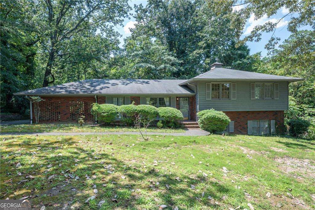 **Charming Brick Home in Desirable Brookwood Area - Fresh paint throughout home!** Welcome to your future home in the established Brookwood neighborhood! This delightful 4-bedroom, 3-full-bathroom brick split-level residence offers a peaceful and serene setting. Step inside and discover an older home filled with charm and character, just waiting for your personal touch. Wood flooring on main level. Hidden beneath the upstairs carpeting, you will find original hardwood floors waiting to be uncovered and cherished. With spacious rooms and a thoughtful layout, there's plenty of space to make this home uniquely yours. The inviting living areas are perfect for family gatherings and entertaining guests, while the bedrooms provide a quiet retreat. Sit on your back patio surrounded by the tranquil sights and sounds of nature. Make this delightful property in Brookwood your own and enjoy the comfort and charm it has to offer. Don't miss this opportunity to live in a peaceful setting in an established neighborhood. Schedule a viewing today and envision the possibilities!