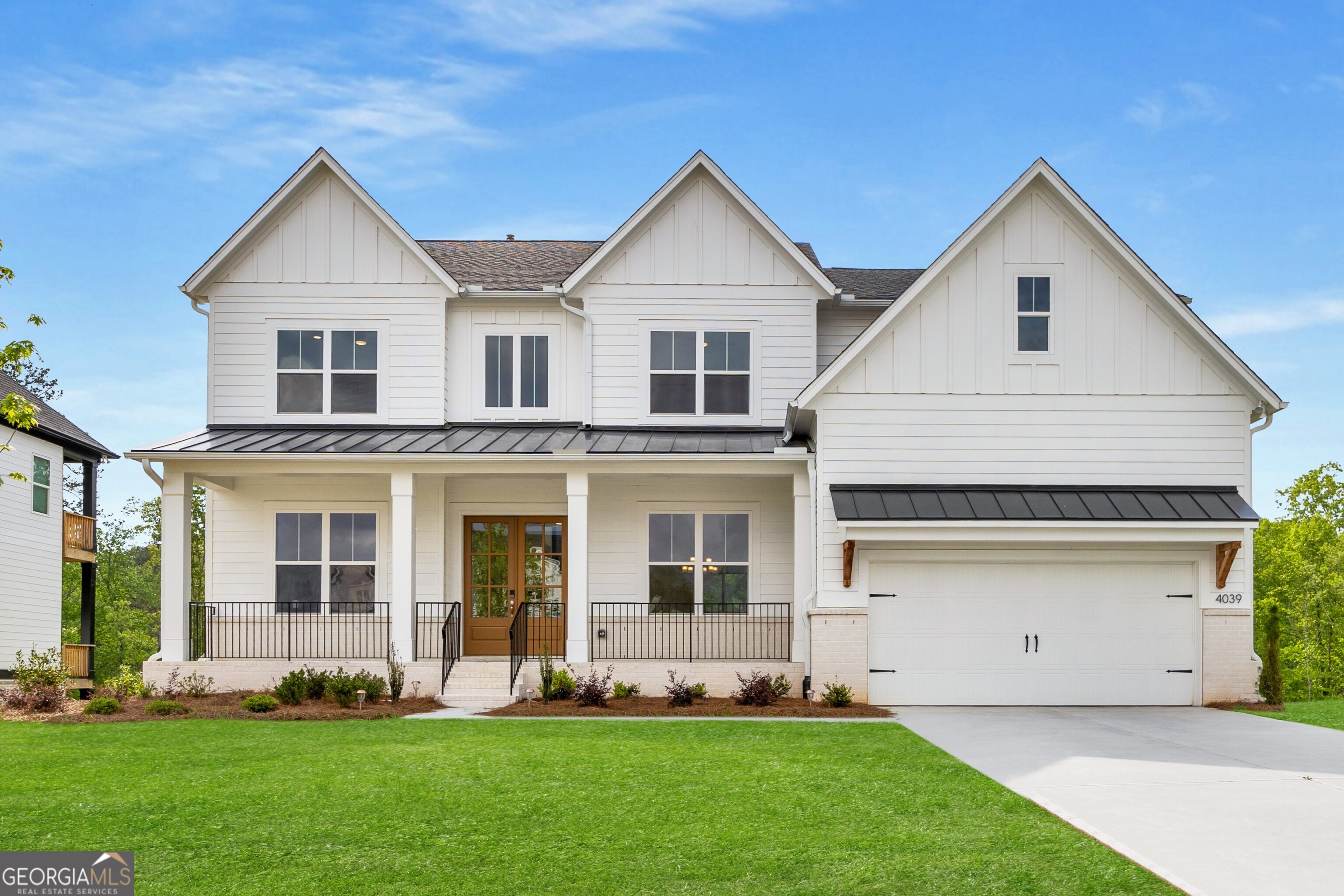 Experience Elevated Living in This Rare, Brand-New Toll Brothers Lakefront Masterpiece in the Coveted Holly Farms Community. Perfectly tucked on a Quiet Cul-De-Sac between Woodstock and Milton, this Modern White Farmhouse is one of only four Exclusive Lakeview Lots, blending High-End Design, Everyday Comfort, and Unmatched Outdoor Serenity. A Beautiful Wood Front Door and Covered Front Porch set the stage, inviting you into a Soaring Two-Story Foyer bathed in Natural Light. Wide-Plank Natural Hickory Hardwood Floors flow throughout the main level, offering warmth and elegance at every turn. To the right, a Formal Dining Room provides the perfect backdrop for special occasions, while the open-concept Living Area centers around a Floor-to-Ceiling Tiled Gas Fireplace. Expansive Sliding Glass Doors fully retract to reveal a Covered Outdoor Deck overlooking the Lake and a Lush, 15,000+ Square Foot Lot creating a seamless Indoor-Outdoor Experience with Exceptional Privacy. The Showstopping Chef's Kitchen is the Heart of the Home, complete with Top-of-the-Line Stainless Steel Appliances, Custom Cabinetry, a Handcrafted Tile Backsplash, Walk-In Pantry, and an Oversized Quartz Island built for gathering. A Bright, Window-Lined Breakfast Nook is ideal for casual meals, while a thoughtfully placed Dry Bar connects the Kitchen and Dining Room perfect for morning coffee or cocktail hour. A Flexible Main Level Bonus Room offers endless possibilities as a Home Office, Playroom, or Sitting Room. Nearby, a Private Guest Suite features a Generously Sized Bedroom and an Elegant En-Suite Bathroom with High-End Finishes. A Convenient Powder Room is tucked just off the main living area. Upstairs, the Owner's Retreat is a Private Sanctuary designed with both luxury and tranquility in mind. Enjoy Peaceful Lake Views from your bedroom, and unwind in the Spa-Inspired Bathroom with Wood and Gold Accents, Dual Vanities, a Large Soaking Tub with Herringbone Tile, and a High-Tech Rain Shower featuring Three Body Jets, Ceiling-Mounted Rainhead, Dual Wall Shower Heads all controlled by Smartphone or Digital Panel. A Massive Walk-In Closet completes this dreamy retreat. Four Additional Upstairs Bedrooms each offer En-Suite Baths with Designer Tile, Quartz Counters, and Premium Fixtures. The second level also includes a Spacious Laundry Room with Extra Storage and Eye-Catching Patterned Tile Flooring. Downstairs, the Full Daylight Walkout Basement with Eleven Full-Size Windows and Glass Doors is Partially Finished and Ready to Customize. Whether you envision a Home Theater, Gym, Playroom, Extra Bedrooms, or Office Space, the potential is endless. Already Fully Insulated and equipped with a Sump Pump, it's a solid foundation for future expansion while offering excellent Storage. This home is loaded with Modern Conveniences, including Energy-Efficient Systems, Separate Climate Controls on Each Floor, a Garage EV Charger, Smart Home Technology, Whole-House Gigabit WiFi, and Three Tankless Navien Water Heaters plumbed to work in tandem for maximum efficiency. Holly Farms offers more than just a place to live it's a lifestyle. Enjoy Scenic Lake Walks, a Resort-Style Pool and Cabana, Pickleball Courts, and a True Sense of Community. All just minutes from Downtown Alpharetta, Halcyon, Crabapple, Avalon, Canton Street, and Premier Golf Courses with access to Top-Rated Schools and endless Shopping, Dining, and Entertainment options. This is more than a home, it's your forever destination!