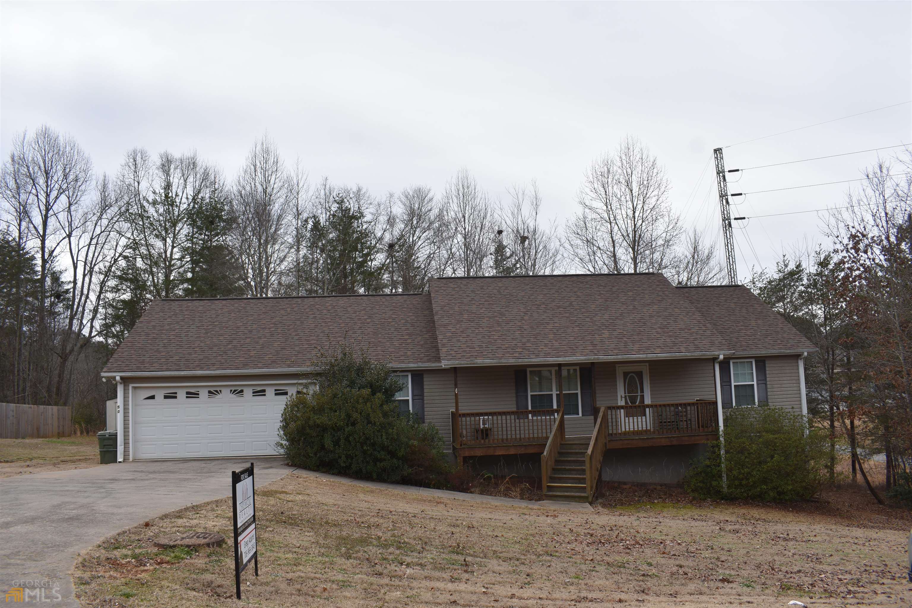 This home is conveniently located to Cleveland close to shopping and restaurants. It sits on a 1.13 acre lot with a 2 car garage and both front porch and back deck are covered. The back yard is fenced in with a storage building. It has 2 bedrooms on one end of the house that share a bathroom. The large master and bath is on the other end of the house. The living room has vaulted ceilings and a ventless fire place that has never been used. The kitchen has plenty of counter space with a breakfast bar. The home has been taken care of on the inside, so don't let this one pass you by, schedule a showing today!!