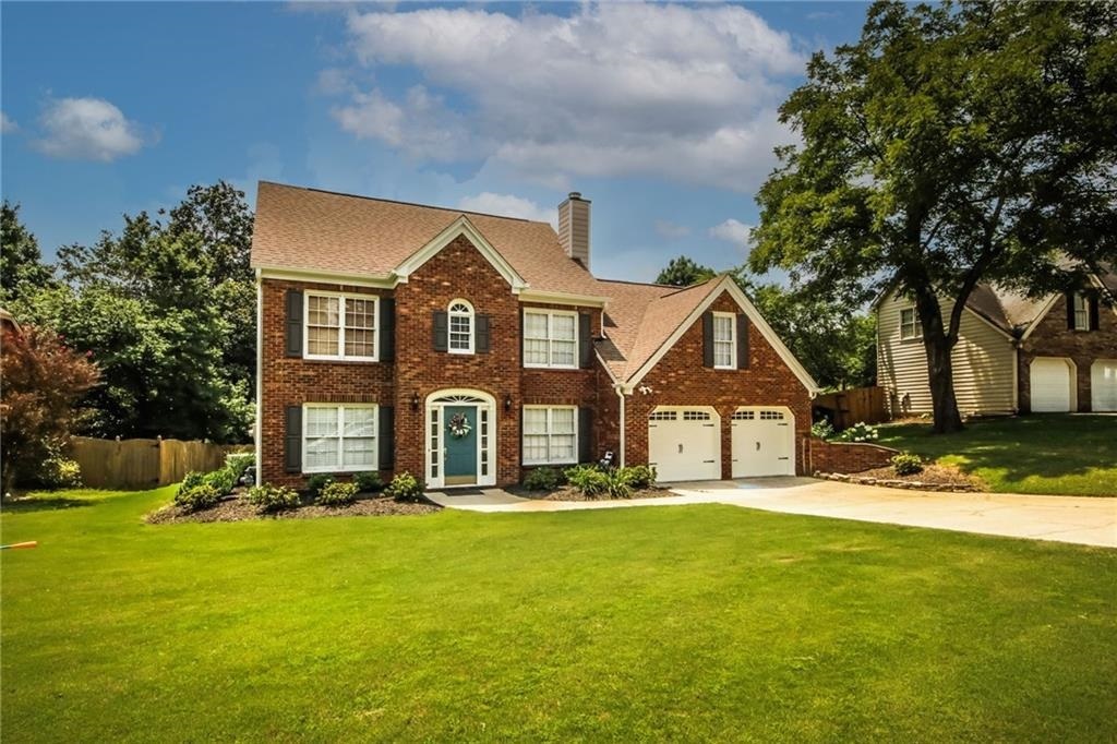 This 4br/2.5ba traditional home has hardwood floors throughout the home up and down. Open concept kitchen to family room with wood-burning fireplace. Kitchen features SS appliances, island with sink, easy-access pantry and separate breakfast area. Large master bedroom w/trey ceilings & huge walk-in closet. Master bath has double vanities, garden tub & separate shower. Outside you'll find the large flat, open backyard with wooded area on over -+ acre, and covered patio off kitchen. Professional landscaping; cement siding installed 2019 and other updates you'll appreciate! Expansive sunroom with tall ceiling boasts lots of windows to let in natural light; overlooks private backyard. Yard is flat from front to back, on over ½ acre, with wooded area bordering creek in far back. Short walk to the neighborhood pool.