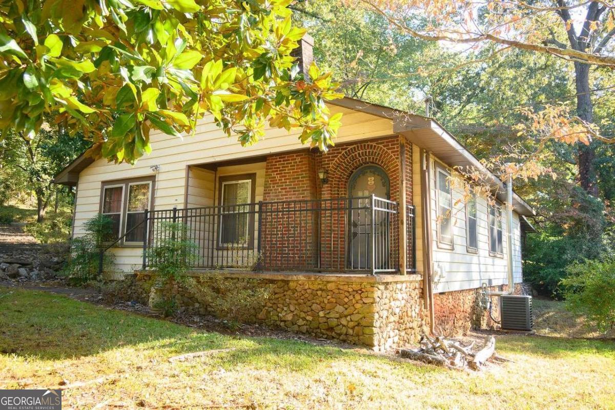 This handyman special is more than just a house; it's an opportunity to create a unique and charming haven that reflects your personal style and vision. This cute little cottage is full of potential just waiting to be realized! As you approach the property, you'll be greeted by the quaint architectural touches that make this cottage special. From the beautiful Magnolia tree outfront, to the arched doorways, this home radiates old-world charm. Step inside, and you'll find a cozy interior that's ready for your personal touch. New hardwood flooring throughout the living room and hallway. The large lot size is a rare find in City Limits, offering ample space for expansion, gardening, or outdoor activities. Imagine the possibilities for a lush garden or a serene patio. This generous lot gives you the freedom to customize your outdoor oasis as you see fit. Don't miss out on the chance to make this property your own and unlock its potential!