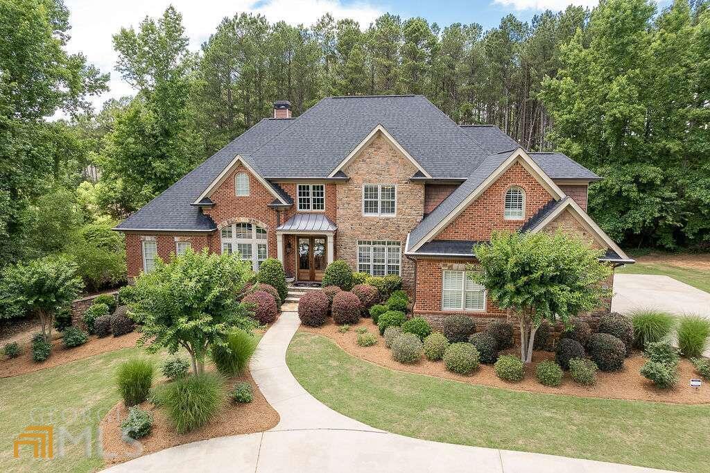 Exquisite 6 bedroom dream home in North Oconee! As you enter the oversized, double front doors you will immediately notice the bright and airy feel of the home. A formal dining room and office with glass doors flank either side of the Grand Foyer. Designed with an open concept, the Two-Story Great Room has a marble fireplace and stately custom built-ins. The Great Room flows into the huge Chef's Kitchen complete with professional appliances, custom cabinets, enormous L-shaped island with breakfast bar, walk-in pantry with wooden shelving and separate breakfast room. Fully-finished screen porch with tile flooring is off the kitchen and an open deck with trex and metal railings complete the entertaining space on the main level. The owner's suite is perfectly tucked away on the main level and features a wall of windows in the bedroom, along with a beautifully tiled king-sized bathroom with a double vanity, tub and separate shower with obscured glass for privacy. The walk-in closet has custom shelving to keep everything in its place! Past the kitchen is a secondary bedroom with walk-in closet and full bath. The laundry room is also on the main level complete with cabinetry and a sink. Upstairs there are 3 additional large secondary bedrooms, all with their own bathroom and walk-in closet and also a loft space. Downstairs, the terrace level features the same detail of the rest of the home and includes a living room with a bar, game room, theater room, fitness room/6th bedroom, a full bath and tons of storage space! A full covered patio to enjoy the shady backyard finishes off the space. Custom trim package throughout, custom shutters throughout (including terrace level), tons of natural light, hardwood floors on entire main level, custom shelving in every walk-in closet and much, much more. Well maintained and conveniently located, you do not want to miss this one! Come see this beauty today!
