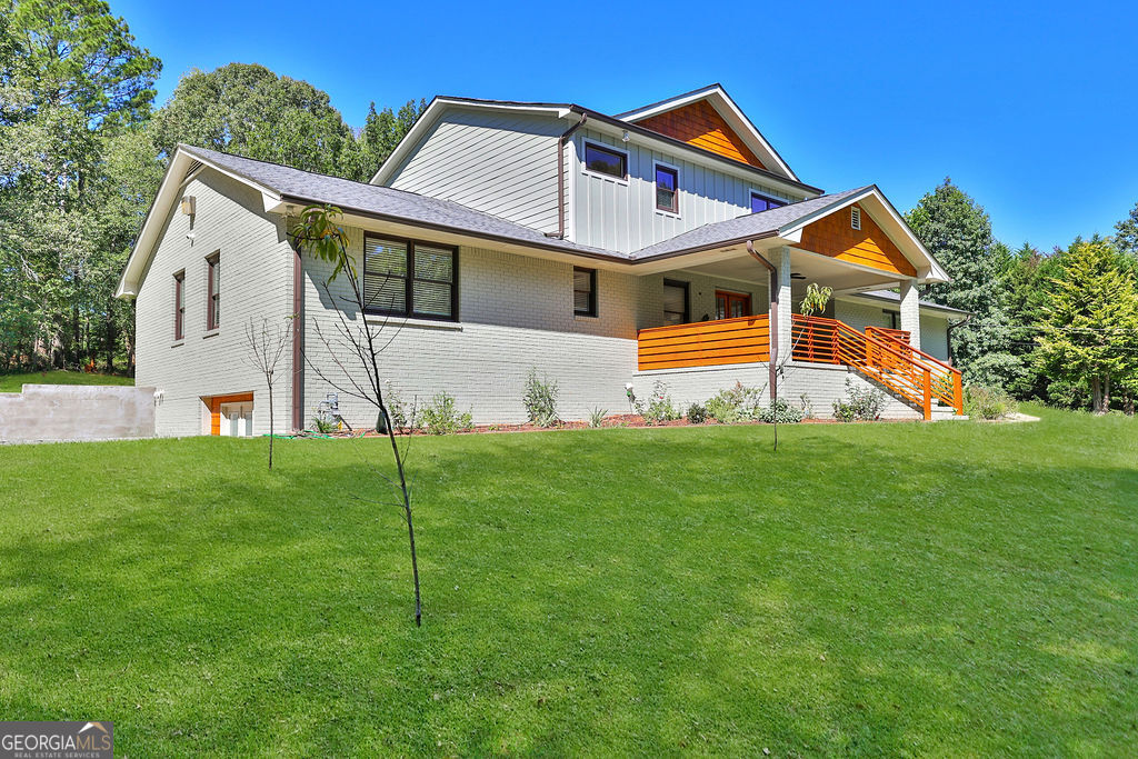 Prepare to fall in love with this stunning 5-bedroom, 4-bath modern farmhouse retreat in the heart of Conyers! Fully renovated in 2022 with all-new systems and contemporary finishes, this home effortlessly blends timeless charm with modern sophistication-all set on 8.64 acres of private, scenic land with trails, RV/boat parking, and plenty of room to roam. From the moment you arrive, the inviting covered porch, lush landscaping, and fruit trees welcome you home. Step through elegant French doors into a bright, open floor plan filled with natural light, gleaming Polyflor hardwoods, and custom details including wainscoting, crown molding, and graceful archways. The chef's kitchen is the true heart of the home, featuring quartz countertops, subway tile backsplash, stainless steel appliances (including a gas stove with vent hood), a farm sink, breakfast bar, and cozy breakfast area-all with views of the covered sundeck and private wooded backyard. This home is uniquely designed with three oversized primary suites, each with walk-in closets and beautifully appointed en-suite bathrooms. The main-level suites boast features like a bay window sitting area, double vanities, and tiled finishes, while the upstairs suite offers a spa-inspired bath with dual vanities, LED mirrors, and a sleek wet-room tub/shower. Secondary bedrooms are spacious and versatile, perfect for family, guests, or home offices. Additional highlights include: *A sunroom with wrap-around bench seating (ideal as a flex room or lounge) *A full daylight basement, already framed for a kitchen and two bedrooms * Covered porch and sundeck for outdoor entertaining * Designated RV and boat parking with a new asphalt driveway * Wired surveillance system for peace of mind. * Every inch of this home is 3 years new-from plumbing and electrical to the septic system and second-story addition. The only original feature is the timeless 4-sided brick exterior. Whether you're gathering around the custom fireplace, exploring your private trails on an ATV, or simply enjoying the serenity of nature, this property is a true escape with easy access to Downtown Atlanta in just 30-45 minutes. Welcome Home-where modern luxury meets farmhouse charm on a breathtaking private estate!