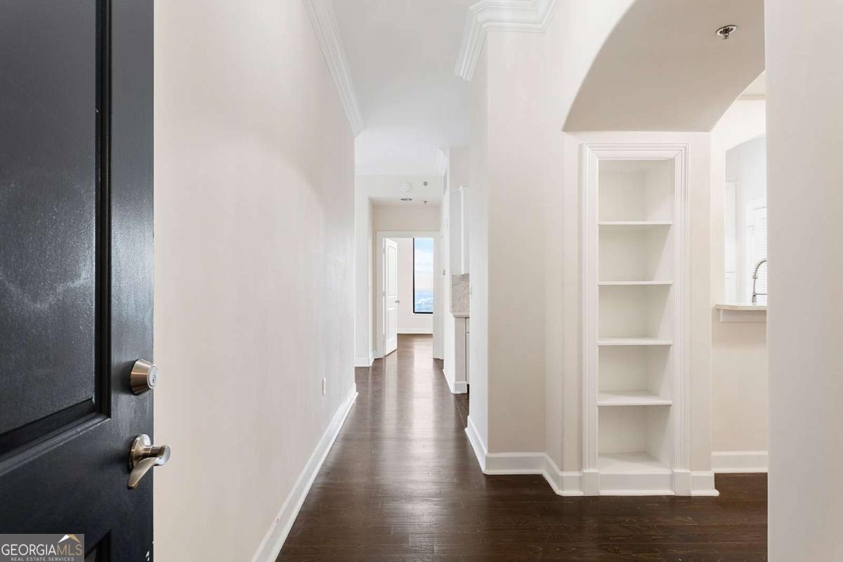 BUCKHEAD LUXURY LIVING AT ITS FINEST with The stunning city and sunset views from the 34th floor in this completely renovated from start to finish. As you walk in on your right you will notice the large den perfect for office space or an additional bedroom ! As you walk past the FULLY renovated kitchen with added custom cabinet space for storage, granite counter tops with all new SS appliances, don?t miss the amazing views into your dining and living area that is perfect for entertaining. Hardwood floors throughout with a huge walk-in closet with custom designed California Closets ! Gorgeous renovated bathroom has new sinks, faucets, cabinets, and counter tops and built in shower !Enjoy your glass of wine out on the huge balcony in the evenings and enjoy the most amazing sunsets throughout your unit. This unit comes with a rare large deeded garage with extra room for storage located on the Top floor of the parking deck and a custom wine locker in the private wine room located in the Divine lounge ! Unit has newer HVAC and tankless water heater complete with a custom water filtration. Step outside of Paramount, and you're in the heart of it all. Treat yourself to a nice massage at the Waldorf Astoria next door , easy access to MARTA to go in to town or airport, enjoy the delights of award-winning restaurant such as NOBU, ARIA, LITTLE ALLEY STEAKHOUSE, MAGGIANO'S, or indulge in retail therapy at Lenox and Phipps Malls. You are in close proximity to I- 75, I-85, I-400 and within 15 mins to the airport. The Paramount has a unique short cut behind the building to escape all of the busy traffic on Peachtree and directly goes to Lenox to 400!!