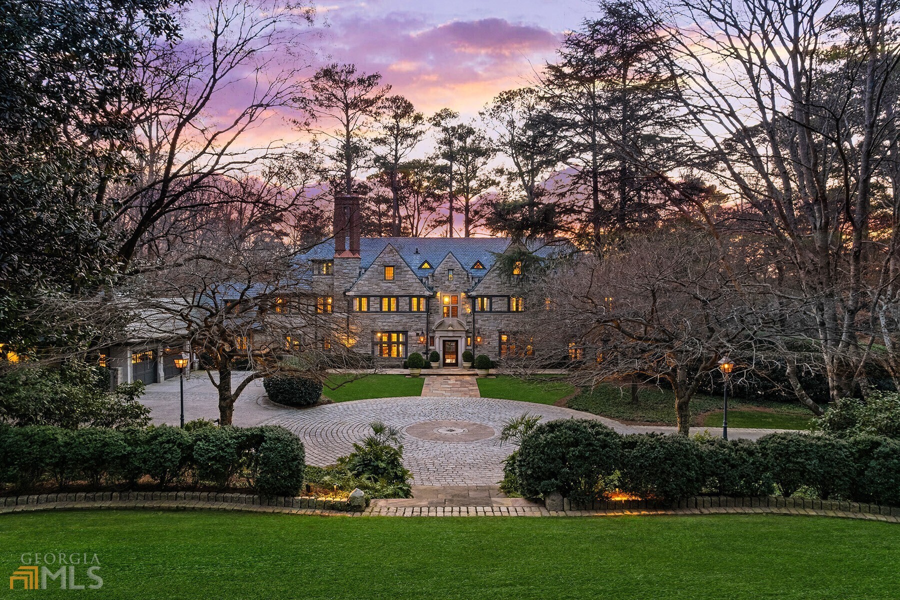 One of Atlanta's most beautiful estates, 3015 Andrews Drive was originally constructed in 1929 and was later expanded for today's lifestyle by renowned architect, Keith Summerour. Sited on nearly 3 acres, the home welcomes with the gated driveway leading to the large motor court. This stunning estate is designed with entertaining in mind. The welcoming foyer is flanked on either side by the formal dining room and formal living room which leads to the bright stone garden room with French arched doors. The cozy family room is adjacent to the fireside kitchen with a La Cornue range, two Sub-Zero refrigerators, two dishwashers, ice maker, large center island and breakfast area. There is also a butlers pantry located adjacent to the kitchen. Upstairs is the owner's suite with his and her baths and separate closets. Three additional bedrooms complete the second level of the home - one of these bedrooms has been converted into a stunning custom closet. On the third floor of the home is a great suite complete with sitting/TV/play room, one bedroom and full bathroom. On the terrace level of the home is a TV room, wine cellar and gym. In the separate carriage house is a kitchenette, living room, bedroom, full bath and two-car garage. The exterior of the home is equally as stunning as the interiors, featuring a pool, flat play yard and multiple terraces overlooking the mature landscaping, which was thoughtfully designed by John Howard with Howard Design Studio.