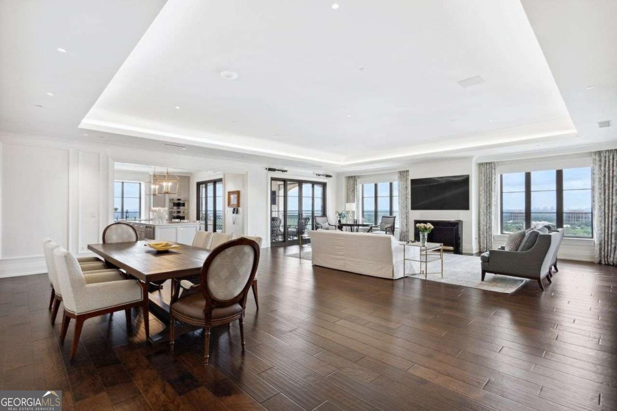 This is a GREAT BUY - Sellers are seriously motivated! Prepare to be wowed when you step from the PRIVATE ELEVATOR into the welcoming foyer of this NEWLY RENOVATED, stunning abode with unobstructed, unparalleled, spectacular views. Boasting 11' ceilings throughout, this sophisticated unit offers the finest in finishes and an airy open floor plan. The Living/Great Room has cove lighting, an inviting fireplace and is open to a gracious size Dining Area with wonderful walls to showcase art. It flows to the state of the art Kitchen from Artistic Cabinetry and Design with quartzite counters, island with seating, SubZero fridge, paneled cabinet appliances, Dacor microwave, Wolf range (6 gas burners and grill), Wolf double wall ovens, Bosch dishwasher, stainless deep sink, lots of pullout racks in cabinets and a breathtaking view from Kitchen window, all opening up to the wonderful covered Balcony with fireplace, TV and outdoor gas grill. The stylish wet bar boasts stone counters, 2 SubZero refrigerated drawers, beverage/wine fridge, ice maker and sink. The 2nd Bedroom features a cleverly designed Murphy Bed, plenty of storage, drawers, hanging space, TV and, when not in use for sleeping, it's a handsome Office or Den. The adjoining marble Bathroom features a beautiful vanity and a large walk-in shower with built-in bench. The elegant oversized Primary Suite features a gorgeous marble Bathroom with double vanities, soaking tub, large walk-in shower with bench, private Toto commode, large linen closet and a massive custom closet with huge island, cabinets, dressing area and plenty of hanging and shoe space. It leads into a tucked away private office. The large Laundry Room has marble counters, sink, cabinetry and accommodates full size appliances. Finally, the secluded back Service room with another private elevator, (this is where the Concierge service discretely delivers your dry cleaning and packages!) has a great Pantry, loads of cabinets with storage and drawers, AV and Crestron Automation equipment. Other features: automated blinds and drapes, Cat 6 throughout, Meridian Sound system, new HVACs, humidifier and more. There are gorgeous wide plank hardwood floors throughout all living/sleeping areas, a COVETED PRIVATE, DEEDED 2 CAR GARAGE (only 26!), large climate controlled STORAGE ROOM, access to world-class amenities of the pool, full service spa, fitness center, restaurants - the fabulous Atlas, the St. Regis Bar and the Garden Room - 24 hour room service, and a dedicated award winning concierge service. Atlanta's finest shopping and dining district is just steps away. Living at the St. Regis is as good as it gets for those who deserve nothing but the best. This residence is the epitome of luxury and exceptional living, offering space, floor to ceiling windows, views from all rooms and an enviable lifestyle waiting to make it yours.
