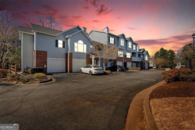 Vinings Forest is one of Smyrna's most affordable gated swimming pool communities, conveniently located just minutes from The Smyrna Market Village, The Battery, Buckhead, and the airport, and across the street from FOOD TRUCK TUESDAY! This 2-bedroom, 2.5-bathroom unit with a 2-car garage features an ideal roommate floor plan with bedrooms on opposite sides for added privacy. The Dining area and Kitchen have BRAND NEW Hardwood floors, installed July 2025. The kitchen features freshly painted white cabinets, granite countertops, a modern backsplash, and newer appliances. The primary suite also has vaulted ceilings and hardwood floors, en suite bath with a double vanity, a tub/shower, and a walk-in closet. The second bedroom is equally spacious, offering an en-suite bath and a large walk-in closet. The home was recently painted and MOVE IN READY! Residents can enjoy morning coffee or evening drinks on the private covered patio. The oversized 2-car garage, featuring epoxy floors, provides extra storage space. Don't miss the dog park at the back of the community or this chance to live in Vinings Forest... These units sell quickly!!!