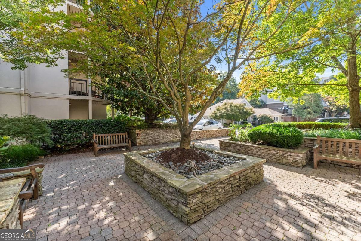 Welcome to 1406 River Green Drive - a beautifully maintained 1-bedroom, 1 bath condo in a prime Atlanta location near Vinings and Buckhead! This thoughtfully designed home offers a spacious open-concept layout featuring a bright family room and dining area that flows seamlessly into the updated kitchen, complete with granite countertops, stainless steel appliances, and a convenient view into the living space - perfect for entertaining. Enter the home to find hardwood flooring, neutral paint colors, and loads of natural light. The master bedroom is a great size and features a walk in closet and en suite bath with an oversized tile shower and modern black vanity and mirror. Step out onto your private balcony to enjoy your morning coffee or unwind at the end of the day. This condo is conveniently located near local shoppes, dining, and roadways to make your commute a breeze. Additional features include: gated entry, bright lobby area, elevator access, great windows, and the laundry room on the same floor within close proximity of the unit. You will enjoy the community amenities such as a secure, gated entry, pool, fitness center, clubhouse, courtyard, grills, dog park, and so much more!