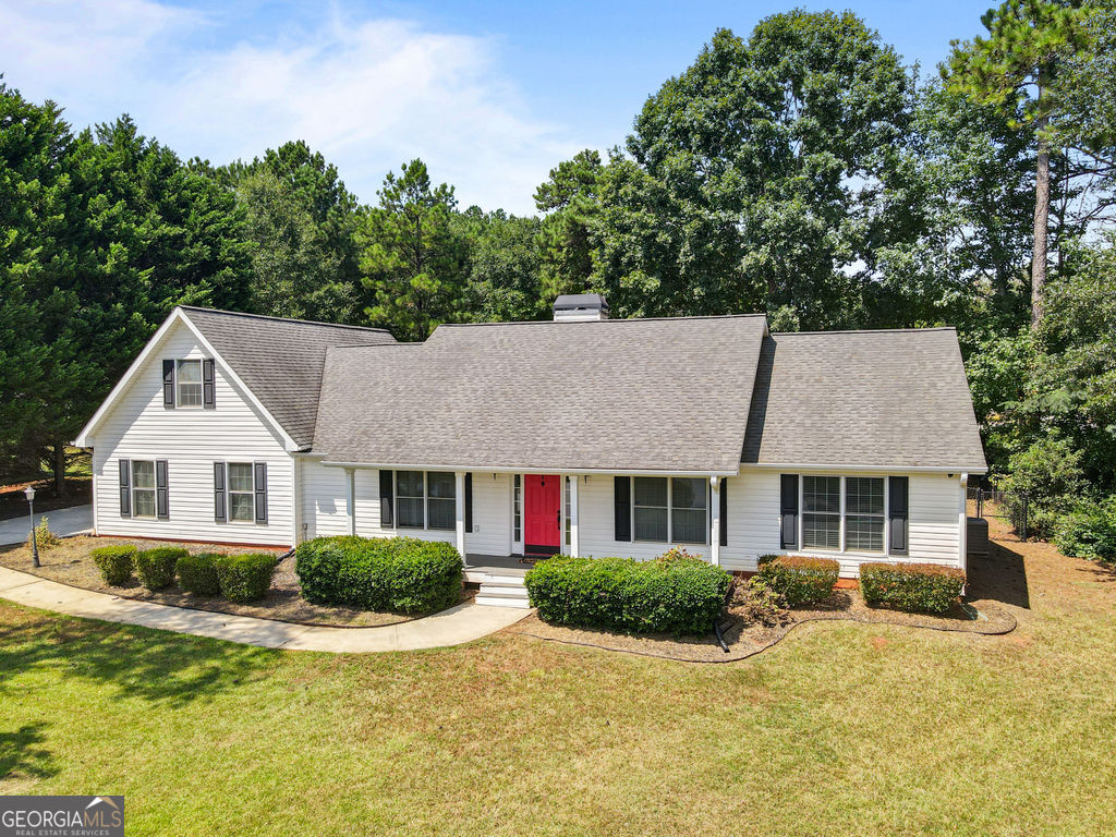 Welcome to this custom home nestled in a quiet, established neighborhood in Newnan, GA. Offering 3 bedrooms, 2 bathrooms, and a versatile bonus room above the 2-car garage, this 2,155 sq ft home combines comfort, function, and charm. Enjoy a lake view right from your front porch, making every morning coffee or evening unwind feel like a retreat. Sitting on just under 1 acre, the expansive lot provides ample space for outdoor living, gardening, and much more-with no HOA restrictions. Inside, you'll find a thoughtful layout with spacious bedrooms and generous living areas with hardwood flooring perfect for relaxing or entertaining. The bonus room is ideal for a home office, media room, playroom, or guest space-tailored to fit your lifestyle. Located in a peaceful neighborhood, you'll enjoy the convenience of being just minutes from downtown Newnan, shopping, and dining. Don't miss your chance to own this move-in ready home!