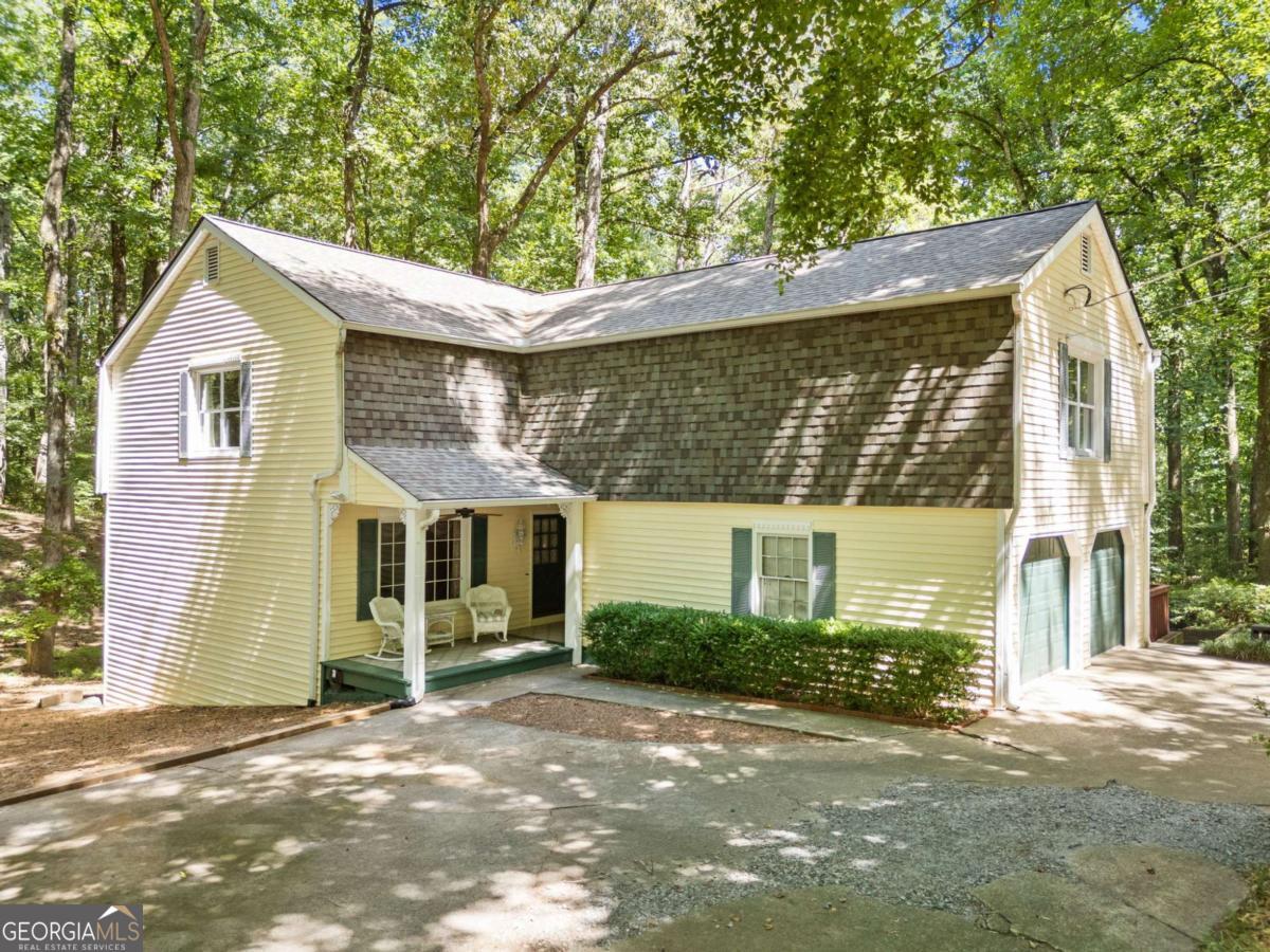 Charming Cottage on Nearly 4 Private Acres in Sought-After Cherokee County School District. Full of character and nestled in a peaceful, wooded setting, this enchanting 4-bedroom, 3.5-bath cottage-style home is situated on almost 4 private acres in one of Cherokee County's most desirable school districts. A circular driveway leads to the classic rocking chair front porch, setting the tone for the charm and comfort that awaits inside. The main level features a welcoming foyer, formal living and dining rooms, a cozy country kitchen, and a spacious great room with abundant natural light-perfect for everyday living and entertaining. A combined laundry/mudroom conveniently connects to the oversized two-car garage for added functionality. Upstairs, the primary suite offers his-and-her walk-in closets and a private bath. Two additional bedrooms each feature large walk-in closets and share a well-appointed hall bath. A dedicated hobby room with built-in storage and an oversized bonus room over the garage (ideal for a playroom, media room, or potential 5th bedroom) provide ample flexibility for any lifestyle. The terrace level expands your living space even further with a large great room, a private office, a full bath, and a spacious bedroom with three closets-perfect for guests, multigenerational living, or a teen suite. Outdoor living is a dream with a wraparound deck offering views of the natural surroundings, plus an older greenhouse outbuilding that's brimming with potential for restoration. Whether you're hosting gatherings or simply enjoying quiet mornings, this peaceful retreat offers unmatched charm and privacy. If you're seeking timeless character, space to grow, and top-tier schools-all wrapped in a tranquil, wooded setting-this unique property is a must-see You said: Expansive deck allows enjoyment of the private backyard , great for entertaining ChatGPT said: Perfect addition! Here's the revised version with your new sentence seamlessly woven in: Charming Cottage on Nearly 4 Private Acres in Sought-After Cherokee County School District Full of character and nestled in a peaceful, wooded setting, this enchanting 4-bedroom, 3.5-bath cottage-style home is situated on almost 4 private acres in one of Cherokee County's most desirable school districts. A circular driveway leads to the classic rocking chair front porch, setting the tone for the charm and comfort that awaits inside. The main level features a welcoming foyer, formal living and dining rooms, a cozy country kitchen, and a spacious great room filled with natural light-perfect for everyday living and entertaining. A combined laundry/mudroom conveniently connects to the oversized two-car garage for added functionality. Upstairs, the primary suite offers his-and-her walk-in closets and a private bath. Two additional bedrooms each feature large walk-in closets and share a well-appointed hall bath. A dedicated hobby room with built-in storage and an oversized bonus room over the garage (ideal for a playroom, media room, or potential 5th bedroom) provide flexible space to fit your needs. The terrace level adds even more living space, complete with a large great room, private office, full bath, and a spacious bedroom with three closets-ideal for guests, teens, or multigenerational living. Enjoy the outdoors on the expansive wraparound deck, perfect for entertaining or relaxing while taking in the tranquil, private backyard. The property also includes an older greenhouse outbuilding, full of potential for restoration and creative use. Offering timeless charm, a versatile floor plan, and a serene setting in a top-rated school district, this one-of-a-kind property is ready to welcome you home.