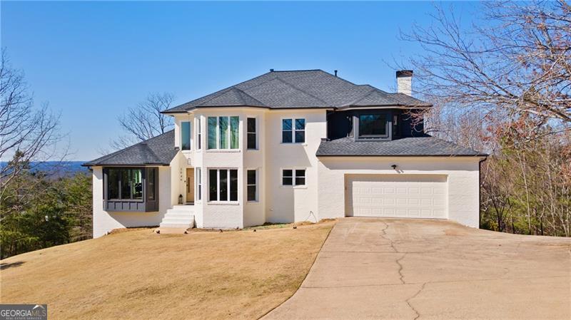 Stunning Mountain Views No HOA Top-Rated Schools Welcome to 2949 Summitop Ct NE, a better-than-new luxury home in the highly acclaimed Lassiter High School district-one of the best in the state! This 7-bedroom, 4-bathroom, 4-sided brick masterpiece sits atop a scenic corner lot offering breathtaking views of Kennesaw Mountain. Step inside to a home that exudes elegance and modern design, starting with a sophisticated staircase and new windows showcasing magnificent views from every angle. The open-concept chef's kitchen is a dream, featuring a massive island with seating, dazzling LAZA quartz countertops, luxury stainless steel appliances, a handle wall-mounted pot filler, custom white cabinetry, and a dedicated wine room. The spacious family room is perfect for entertaining, while the formal dining room provides an elegant setting for gatherings. A main-level guest bedroom/office and a full bath complete the first floor. Upstairs, the oversized owner's suite is a true retreat, boasting breathtaking mountain views right from your bed! The suite features a spa-like bathroom with a custom shower, soaking tub, dual vanities, and a huge his-and-hers walk-in closet with custom shelving. Three additional well-appointed bedrooms and a beautifully finished bath complete the upper level. The fully finished basement is perfect for an in-law suite or additional living space, featuring two bedrooms, a second kitchen with a custom bar, and an expansive playroom. This home is fully upgraded with European White Oak hardwood floors, three brand-new HVAC units, a tankless water heater, a new roof, ceiling fans, LED lighting, fresh paint, and high-end finishes throughout. The expanded garage includes an 18' wide garage door with a freshly installed epoxy finish, and the extra-long driveway provides ample parking. Sitting on 1.33 private acres, this property offers plenty of space for a future pool and more. Located in a prime East Cobb location with easy access to Sandy Plains, Piedmont, Hwy 120, I-75, and top-tier shopping and dining. Zoned for some of the BEST schools in Georgia! Lassiter High Mabry Middle Davis Elementary No HOA! A must-see home! Private tours will begin March 2nd, 2025.