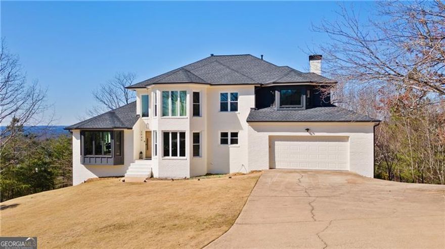 Stunning Mountain Views   No HOA   Top-Rated Schools     Welcome to 2949 Summitop Ct NE, a better-than-new luxury home in the highly acclaimed Lassiter High School district-one of the best in the state! This 7-bedroom, 4-bathroom, 4-sided brick masterpiece sits atop a scenic corner lot offering breathtaking views of Kennesaw Mountain.    Step inside to a home that exudes elegance and modern design, starting with a sophisticated staircase and new windows showcasing magnificent views from every angle. The open-concept chef's kitchen is a dream, featuring a massive island with seating, dazzling LAZA quartz countertops, luxury stainless steel appliances, a handle wall-mounted pot filler, custom white cabinetry, and a dedicated wine room. The spacious family room is perfect for entertaining, while the formal dining room provides an elegant setting for gatherings. A main-level guest bedroom/office and a full bath complete the first floor.    Upstairs, the oversized owner's suite is a true retreat, boasting breathtaking mountain views right from your bed! The suite features a spa-like bathroom with a custom shower, soaking tub, dual vanities, and a huge his-and-hers walk-in closet with custom shelving. Three additional well-appointed bedrooms and a beautifully finished bath complete the upper level.    The fully finished basement is perfect for an in-law suite or additional living space, featuring two bedrooms, a second kitchen with a custom bar, and an expansive playroom.    This home is fully upgraded with European White Oak hardwood floors, three brand-new HVAC units, a tankless water heater, a new roof, ceiling fans, LED lighting, fresh paint, and high-end finishes throughout. The expanded garage includes an 18' wide garage door with a freshly installed epoxy finish, and the extra-long driveway provides ample parking.    Sitting on 1.33 private acres, this property offers plenty of space for a future pool and more. Located in a prime East Cobb location with easy access to Sandy Plains, Piedmont, Hwy 120, I-75, and top-tier shopping and dining.    Zoned for some of the BEST schools in Georgia!  Lassiter High   Mabry Middle   Davis Elementary  No HOA!  A must-see home! Private tours will begin March 2nd, 2025.