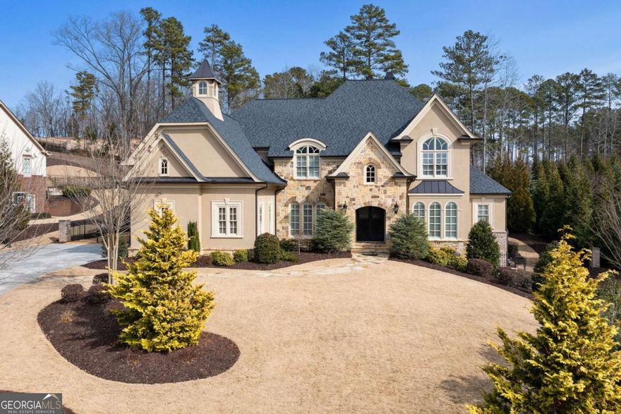 MOTIVATED SELLER - PRICE IMPROVEMENT of $400,000!  Experience the pinnacle of luxury living in this magnificent estate, overlooking the 11th Green in the highly sought-after gated community of The Manor Golf & Country ClubCoone of the most exclusive enclaves in the Southeast with world-class amenities, exceptional privacy, and unparalleled prestige.     This exceptional property offers over 10,000 square feet of refined living space, masterfully designed for elegance and comfort. This dream home includes five oversized bedrooms, with the potential to add a sixth, ensuring ample space for family and guests.      From the moment you enter, youCOll be captivated by the exquisite craftsmanship and thoughtful details throughout. Gleaming upgraded one-and-a-half-inch-thick hardwood floors span the entire residence, exuding timeless sophistication. A striking circular staircase greets you in the grand foyer, setting the tone for the opulence that awaits. An elevator effortlessly connects all levels, ensuring ease of access. The estate boasts a wealth of luxurious amenities to elevate your lifestyle. A full, state-of-the-art gym is perfect for fitness enthusiasts, while the massage room on the upper level provides a tranquil retreat. For evenings of entertainment, indulge in the dedicated movie theater, complete with a dry bar for an elevated cinematic experience. A stunning wine cellar on the main level, crafted with luxurious stone, is the perfect space to showcase your wine collection. The gourmet kitchen is a chefCOs dream, featuring an oversized island, Subzero refrigerators and freezers, Wolf range and three ovens, and an oversized walk-in pantry. Adjacent to the kitchen, the double-story great room and family room offer an impressive space for gathering and relaxation. The primary suite is conveniently located on the main level and serves as a serene retreat. The oversized office on the main level provides the perfect space to work from home in style. Custom-designed walk-in closets offer ample storage, combining functionality with elegance. The home also includes an oversized doggy spa with a large shower, two laundry roomsCoone on the main and another on the upper levelCoand a well-appointed mudroom. The outdoor spaces are nothing short of extraordinary. The private backyard is an entertainerCOs paradise, featuring a sparkling pool, hot tub, outdoor kitchen, fire pit, covered patio with a fireplace, and a second outdoor kitchen. The backyard overlooks the pristine golf course, creating a serene and picturesque setting. DonCOt miss your chance to experience this architectural masterpiece. Schedule your private tour today and discover what makes this property truly extraordinary.