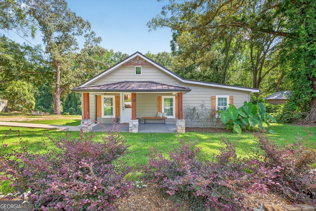 Welcome to 1217 Mize Road, a beautifully updated 2-bedroom, 2-bath cottage in the quaint and inviting town of Toccoa. Perfectly located just minutes from downtown, Toccoa Falls College, and Currahee Vineyard, this home offers the perfect blend of small-town charm and modern upgrades. Step inside to a spacious family room featuring stunning LVP flooring throughout, a vaulted ceiling with recessed lighting, and an airy open floor plan. The gourmet island kitchen is a chef's dream with granite countertops, stylish cabinetry, stainless steel appliances, and a cozy breakfast bar. Just behind the kitchen, you'll find a full laundry room for added convenience. The grand primary suite is a retreat in itself, boasting a luxurious en-suite bath with a gorgeous tile shower, custom dual vanity, and his-and-hers closets. The oversized second bedroom also features dual closets and access to another full bath with a beautiful vanity and shower/tub combo. Enjoy mountain views from the covered front porch, perfect for sipping morning coffee or unwinding in the evening. The spacious property includes a charming creek at the back, adding to the serene setting. Whether you're looking for a full-time home, a weekend getaway, or an investment property, this one is ideal with its proximity to the college, hiking at Toccoa Falls, and the area?s shopping and dining. Don't miss this gem! schedule your showing today!