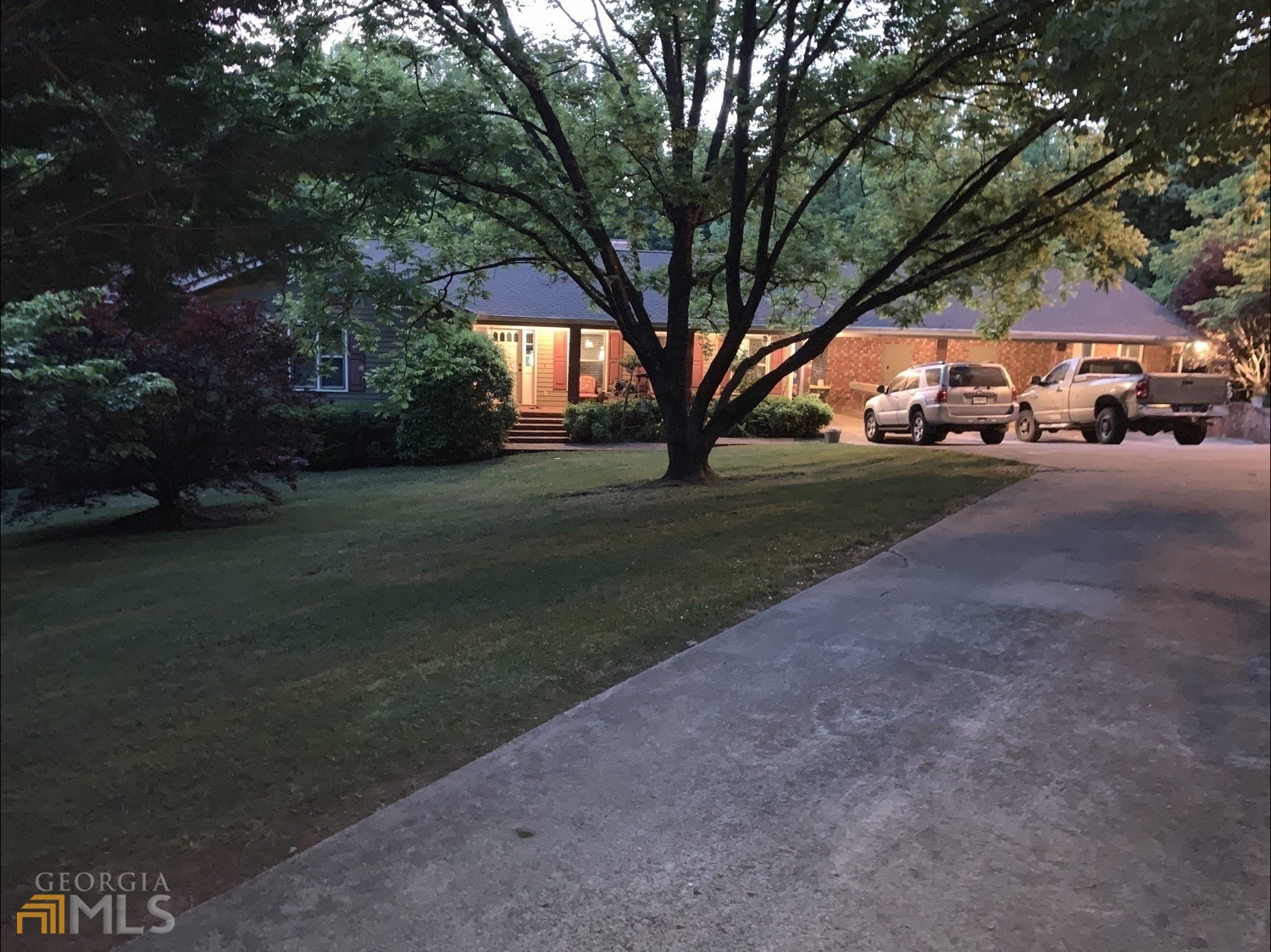 First time this brick home property has been offered "FOR SALE". Spacious 4/3 offers wood floors throughout the main floor with a inviting brick fireplace in the family room. Perfect floor plan for a mother-in-law suite with a separate entrance, private bedroom, full bath, and a living room. Kitchen is bright white with a office/desk area and a pass-through to the dining room. All living space is on the main floor area with easy access to the home from the covered carport. Attached to the carport is an enclosed workshop. Basement includes plenty of storage and a game room area, with a garage door for boats, lawn equipment or antique cars. Perfect established garden area situated on 3.45 acres, When you pull into the nicely shaded driveway with all the beautiful plants and mature hardwoods, you will want to call this place home.