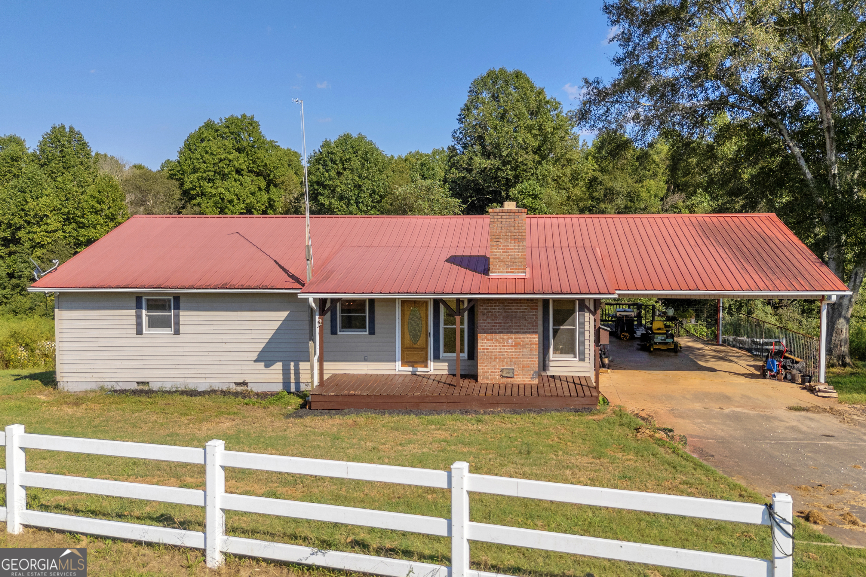 Charming Ranch on Nearly 8 Acres in Bowman, GA - Ready for Your Personal Touch! Welcome to this spacious 3-bedroom, 2-bathroom ranch-style home situated on just under 8 acres of beautiful land in Bowman, GA. Perfectly positioned for privacy, this property offers an abundance of potential and is ideal for anyone looking to update and customize their dream home while enjoying the tranquility of country living. Key Features: 3 Bedrooms, 2 Bathrooms - A comfortable layout with hardwood floors throughout the main living areas, tile flooring in the bathrooms, and carpeted bedrooms. Bonus Room - Extra space for an office, playroom, or den-endless possibilities! Brick Fireplace with Wood Stove Insert - Cozy up in the living room by the warm, crackling fire. Partial Unfinished Basement - Additional storage space or potential for expansion. Large Front Porch - Perfect for relaxing or entertaining while enjoying the scenic views of the surrounding land. Tin Roof - Classic country charm with long-lasting durability. Outdoor Features: Almost 8 Acres of Land - Expansive grounds with large oak trees, lush fenced pasture, and a creek running along the back-ideal for livestock or gardening. Big Barn - A large barn for storing equipment, hay, or housing animals. Wood Shed & Run-in Shed - Convenient structures for storing firewood or providing shelter for animals. Whether you're a hobby farmer, animal lover, or just someone looking for a peaceful retreat, this property has everything you need to create your perfect countryside sanctuary. Bring your animals and enjoy all the space, privacy, and natural beauty this land has to offer. This home is ready for your updates and personal touch! With a little updating, this can be transformed into the perfect family home. Don't miss out on this unique opportunity-schedule your private showing today!