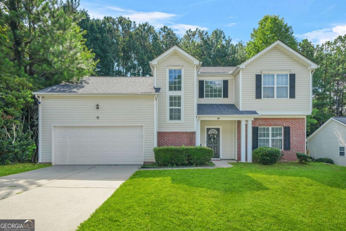 Welcome to this well-maintained 4 bed, 2.5 bath home in a prime Austell location! Inside, enjoy an open-concept layout with a spacious living room featuring a cozy fireplace, an updated kitchen with white cabinetry, stainless steel appliances, center island, and built-in desk nook, plus a separate dining room. The main level also includes a laundry room, half bath, and access to the 2-car garage. Upstairs you'll find four generously sized bedrooms with walk-in closets, including one with a large storage area and crawl space access. The fully renovated bathrooms showcase modern tile work, vanities, and fixtures. Enjoy a large backyard perfect for entertaining or adding your personal touch. Located just minutes from Six Flags, Smyrna, downtown Atlanta, the airport, and major highways including I-20 & I-285-this home offers convenience, space, and style all in one!