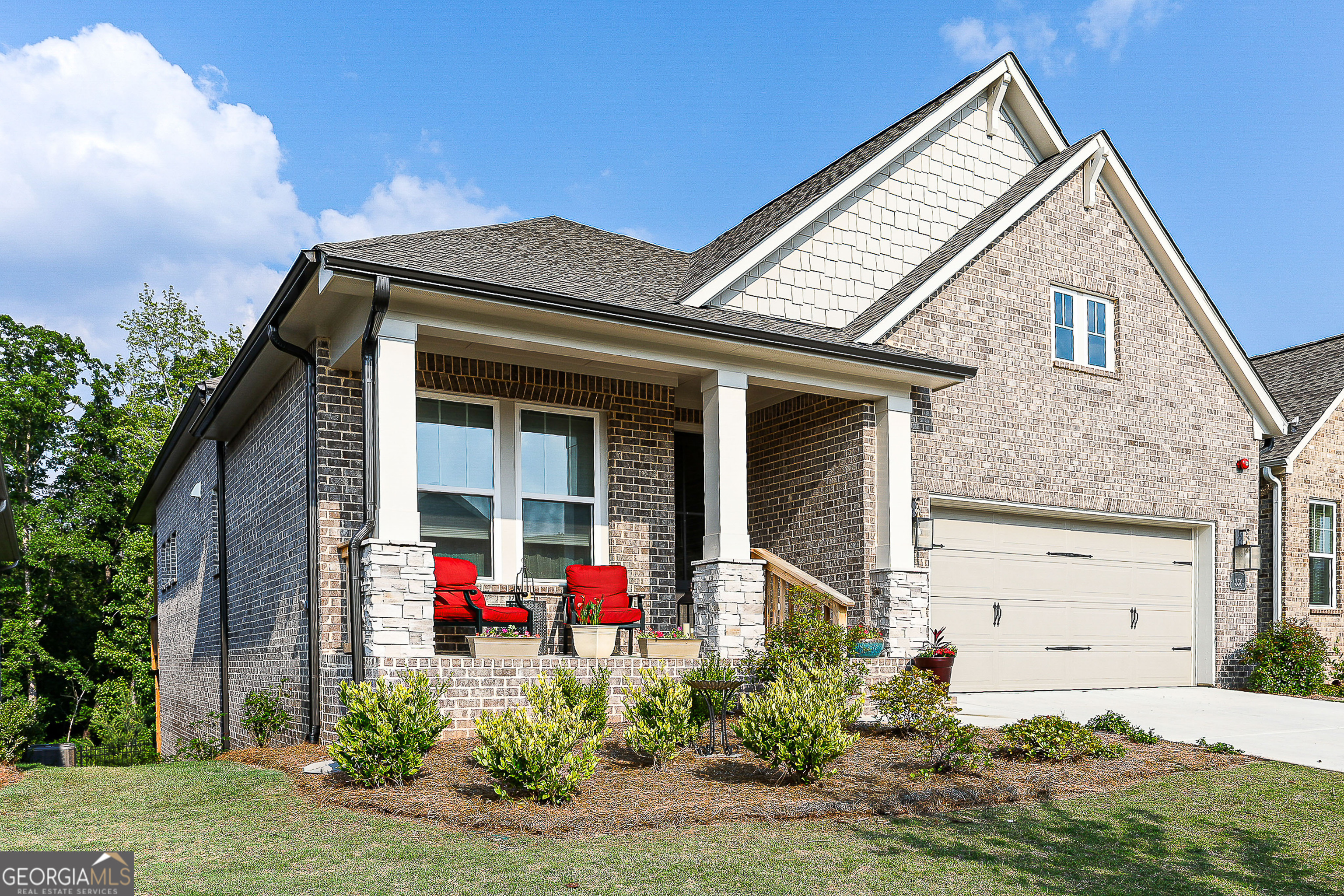 PRICE REFRESHMENT! Unmatched Privacy & Luxury in Woodstock's Premier 55+ Community!**Better than new and truly one-of-a-kind! This 3-sides brick, energy-efficient home sits on a premium lot backing to protected Rope Mill Park woods-your only backyard neighbors will be the wildlife. Property extends 15 ft beyond the fence, ensuring lasting privacy.**Inside, enjoy 11' ceilings, neutral colors throughout, and an open-concept layout designed for modern living. Paint upgrade to sound damping. The chef's kitchen features designer tile, extended-height lit cabinets, a walk-in pantry, and a large island with seating-perfect for entertaining. Plenty of quiet close pull out drawers and cabinetry which will delight any kitchen savvy buyer.**The spacious family room offers a gas fireplace for instant ambiance and easy access to the private deck. The upgraded neutral flooring is an interior decorator's dream come true. In this thoughtful floor plan every window is placed for optimal privacy. The subtle upgrades here are impressive**Oversized luxury owner's suite includes remote blinds and amply sized serene view sitting area. The spa-style bath, split vanities with tower storage, huge walk in closet adds to the Zen like retreat.**You'll also find a second ensuite bedroom on the main floor, perfect for overnight guests, a French-door hardwood floor office complete with floor outlets for printers/computer monitors, a half bath, a laundry room with upgraded cabinetry/ceramic sink, and an amply sized two car, epoxy-coated floored garage.** The daylight basement is ready for finishing -stubbed for a second kitchen and luxury bath, with two additional circuit panels added for a future gym/exercise studio. There is plenty of room to create an entire ground level second living space, perfect for extended visitors or large family gatherings.** Enjoy top-tier community amenities: pickleball courts, lap-lane pool with sun water deck, beautiful clubhouse with yoga studio, fitness center, kitchen, and gathering spaces. HOA dues cover full lawn care-front and back for your home. Leave the yard work behind! All just minutes to charming downtown Woodstock's shopping, dining, trails, amphitheater and more. This is truly a rare, turn-key opportunity-don't wait!