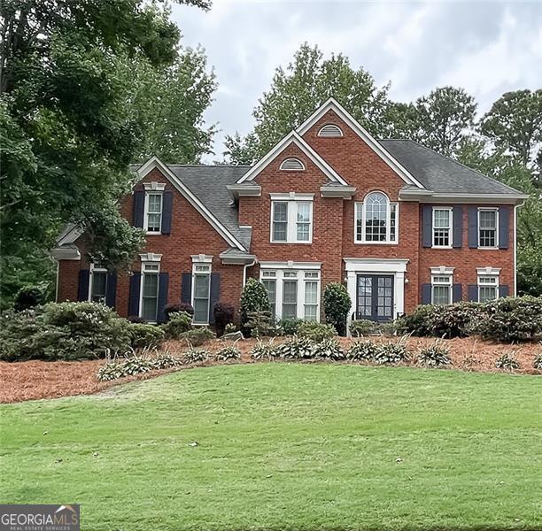 Welcome to this beautifully updated John Weiland-designed home in the popular Hamilton Commons neighborhood. With fresh paint throughout and a recently updated kitchen and bathrooms, this home perfectly blends classic style with modern comfort. Whether you're hosting friends or just relaxing with family, you'll love the open, functional layout and the warm, welcoming feel inside and out. The gourmet chef's kitchen features abundant cabinetry with under-cabinet lighting, granite countertops, a large center island, pantry, second vegetable sink, 6-burner gas stove, and stainless-steel appliances. The kitchen opens to a warm and welcoming family room with exposed beam ceilings, a brick fireplace, built-in shelving, and cabinetry. Double French doors lead to a generous wraparound deck, ideal for entertaining or relaxing. A secondary staircase off the family room provides easy access to the upper level. Adjacent to the dining room, you'll find a serene screened porch overlooking the private backyard, which includes a playhouse, swing set, and irrigation system for both front and back yards. The main level also includes a private home office/study-perfect for remote work, as well as a convenient laundry room. Upstairs, the luxurious primary suite offers hardwood floors, a tray ceiling, spa-like bathroom with soaking tub, oversized shower with five shower heads, dual walk-in closets, and an additional room currently serving as a second laundry area or flexible closet space. The daylight basement provides additional living space with a media/gathering room, bonus bedroom, full bath, bar area, and plenty of storage. Modern upgrades include a full-house Generac generator and a 240V Tesla charger for electric vehicle owners. This thoughtfully maintained home is the perfect blend of luxury, functionality, and location-your new home awaits!