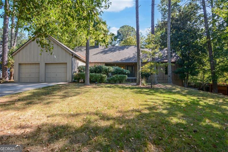 INVESTORS DREAM! Come see this incredible opportunity for a home that has amazing potential. The owner has started some DIY projects and they are ready for you to finish. The beams in this home are from an old barn. Take the spiral staircase up to a private loft. Expand the kitchen into the dining room to create a beautiful kitchen and add a deck to a lot that is just over 1/2 acre right in Peachtree Corners. A double third bedroom can be made back into two bedrooms to make this a four bedroom home, with the primary bedroom on the main. The focal point of this home is the spacious family room with a large fireplace, vaulted ceiling and the beams from the old barn. A new roof installed in 2023 takes away a large expense! Full basement with another garage and garage door. A large Tuff Shed in the backyard with a 10ft custom height ceiling is perfect for a workshop, storage or hang out space. Located on a non-busy cul de sac street, this home is waiting for a renovation top to bottom with endless possibilities. ESTATE SALE COMING SOON!