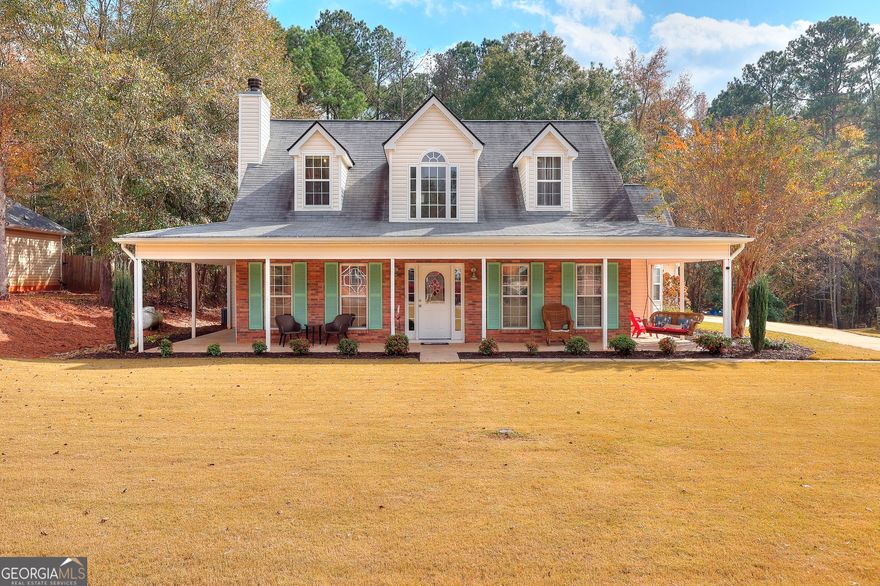 2 story beauty in East Newton County gives the feel of country living but is located just 5 minutes from historic downtown Covington Square. Spacious home with wrap around front porch on a flat, private lot offers a back yard with tons of privacy and loads of curb appeal. Brick front on the main level with a side entry garage. Front door enters into a gorgeous 2 story foyer with decorative window up above with Hardwood flooring. Living room has great carpet, plenty of space to entertain and offers a remote controlled fireplace with gas logs as a nice focal point. Separate dining room with chair rail and hardwood floors and updated lighting. The open kitchen has plenty of storage along with stainless steel appliances. Breakfast area with room for a kitchen table for smaller dinner settings. Laundry room on the main level. Half bath on main level. Master bedroom on main level with new carpet and paint touchups. Large walk in closet in master bathroom. Master bathroom has separate garden tub with jets and a separate shower along with a gorgeous 3 window view offering lots of natural light to the master bathroom. The upper level has 2 large bedrooms with plenty of closet space in both and a full bath between the 2 rooms. Bonus room with new carpet and paint has entry through garage and also an entrance through the house and could be great for teen or in law type suite. Back patio is large and very private. No HOA. All electric home except for gas logs in fireplace. Located close to I-20 for easy commute to anywhere!